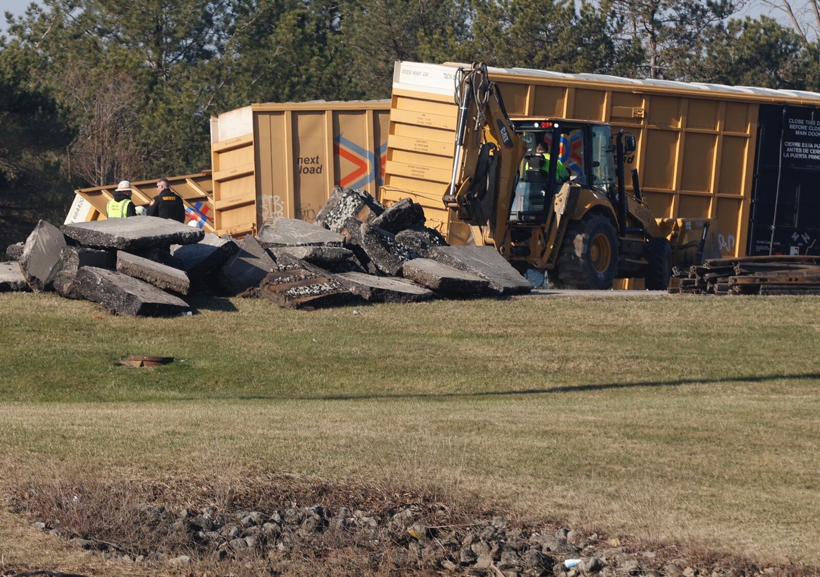 Train company workers clean up Sunday, March 5, 2023 after a train derailment Saturday afternoon at Ohio Route 41 near the Clark County Fairgrounds. BILL LACKEY/STAFF