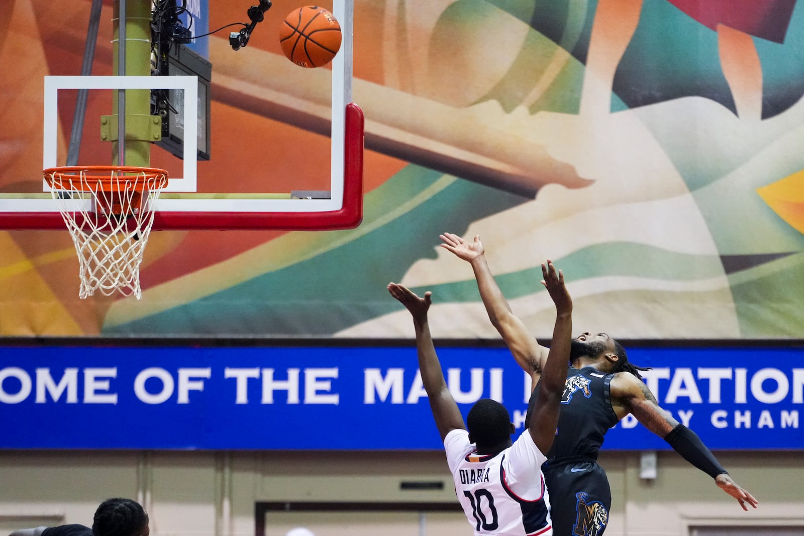 Memphis guard Tyrese Hunter goes up to the basket against UConn guard Hassan Diarra (10) during the first half of an NCAA college basketball game at the Maui Invitational Monday, Nov. 25, 2024, in Lahaina, Hawaii. (AP Photo/Lindsey Wasson)