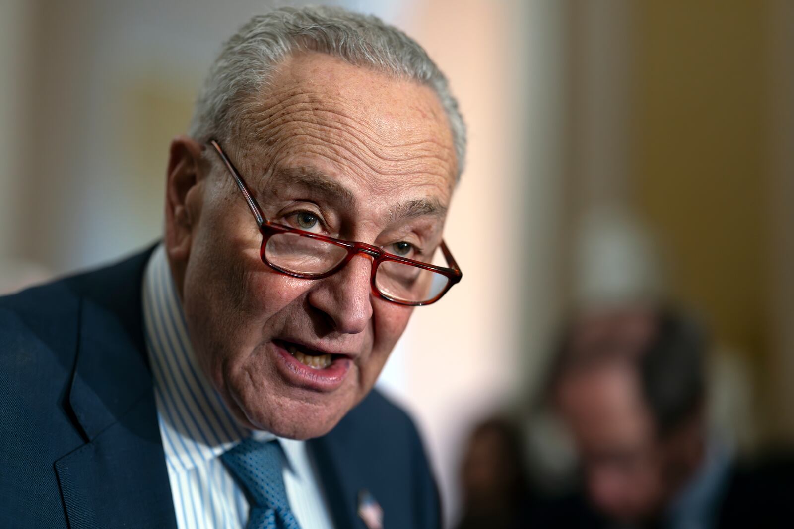 Senate Majority Leader Chuck Schumer, D-N.Y., speaks to reporters following a closed-door strategy session, at the Capitol in Washington, Tuesday, Dec. 17, 2024. Congressional leaders are nearing the unveiling of an agreement that will keep the federal government funded through March 14 and provide more than $100 billion in emergency aid to help states and local communities recover from Hurricanes Helene and Milton, and other natural disasters. (AP Photo/J. Scott Applewhite)