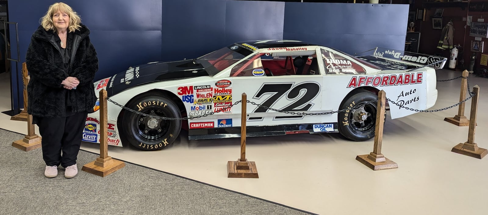 Bob Korn’s daughter Robin stands next to the No. 72 Ford late model stock car which is the centerpiece of the Bob Korn exhibit  that will have its gala opening Saturday at   1.p.m. at the Miamisburg History Center, 35. S. Fifth Street, Miamisburg.  CONTRIBUTED