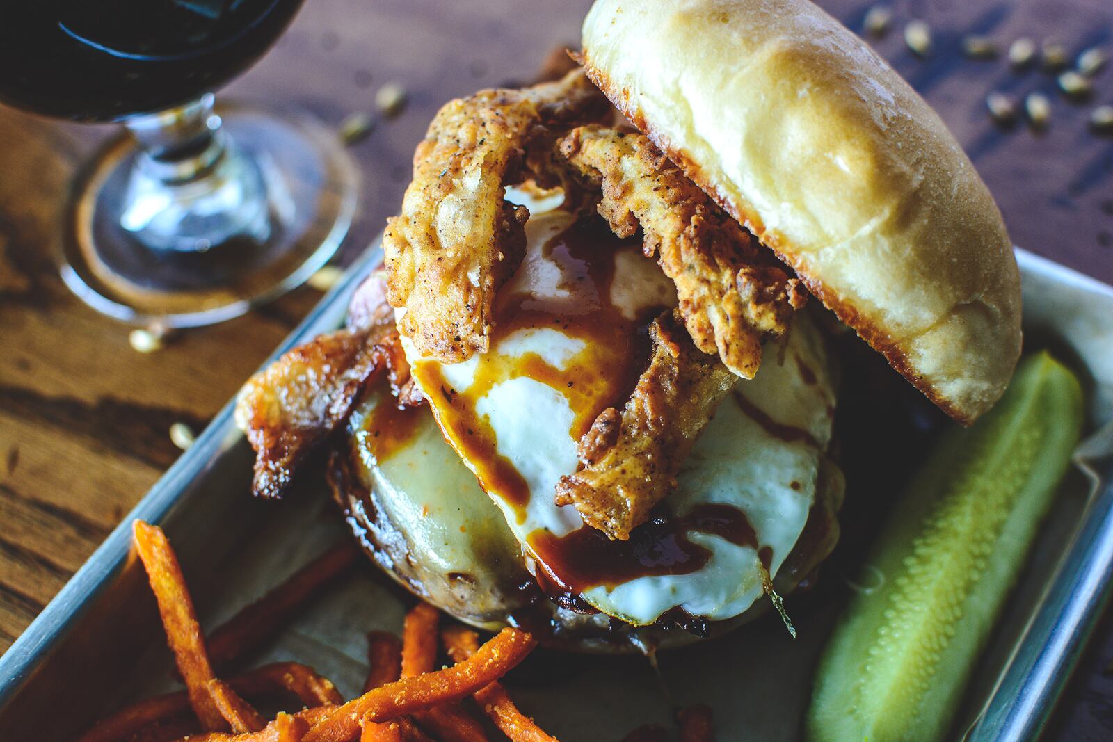 Eurdora Brewing Company's "The Cowboy" burger made with Thunderball Stout barbecue sauce, pepper-jack cheese, bacon, fried onion petals and a fried egg. CONTRIBUTED PHOTO / ABBY HOFRICHTER