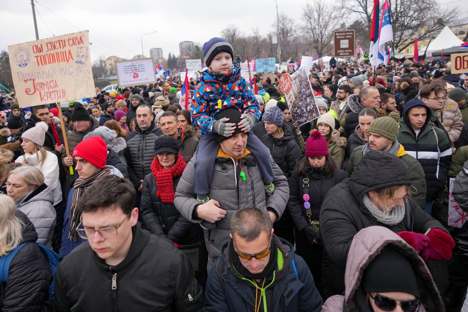 People attend a moment of silence during a protest triggered after a concrete canopy on a railway station in the northern city of Novi Sad collapsed on Nov. 1, 2024 killed 15 people, in Kragujevac, Serbia, Saturday, Feb. 15, 2025. (AP Photo/Darko Vojinovic)