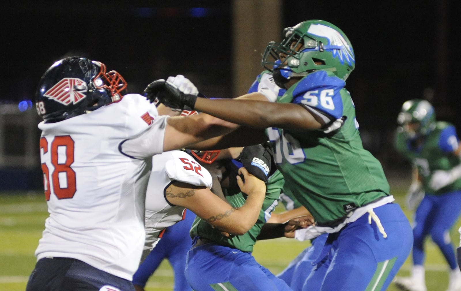 Piqua’s Caden Clark (left) matches up with CJ’s Shane Cokes. CJ defeated visiting Piqua 42-22 in a Week 1 high school football game on Friday, Aug. 24, 2018. MARC PENDLETON / STAFF