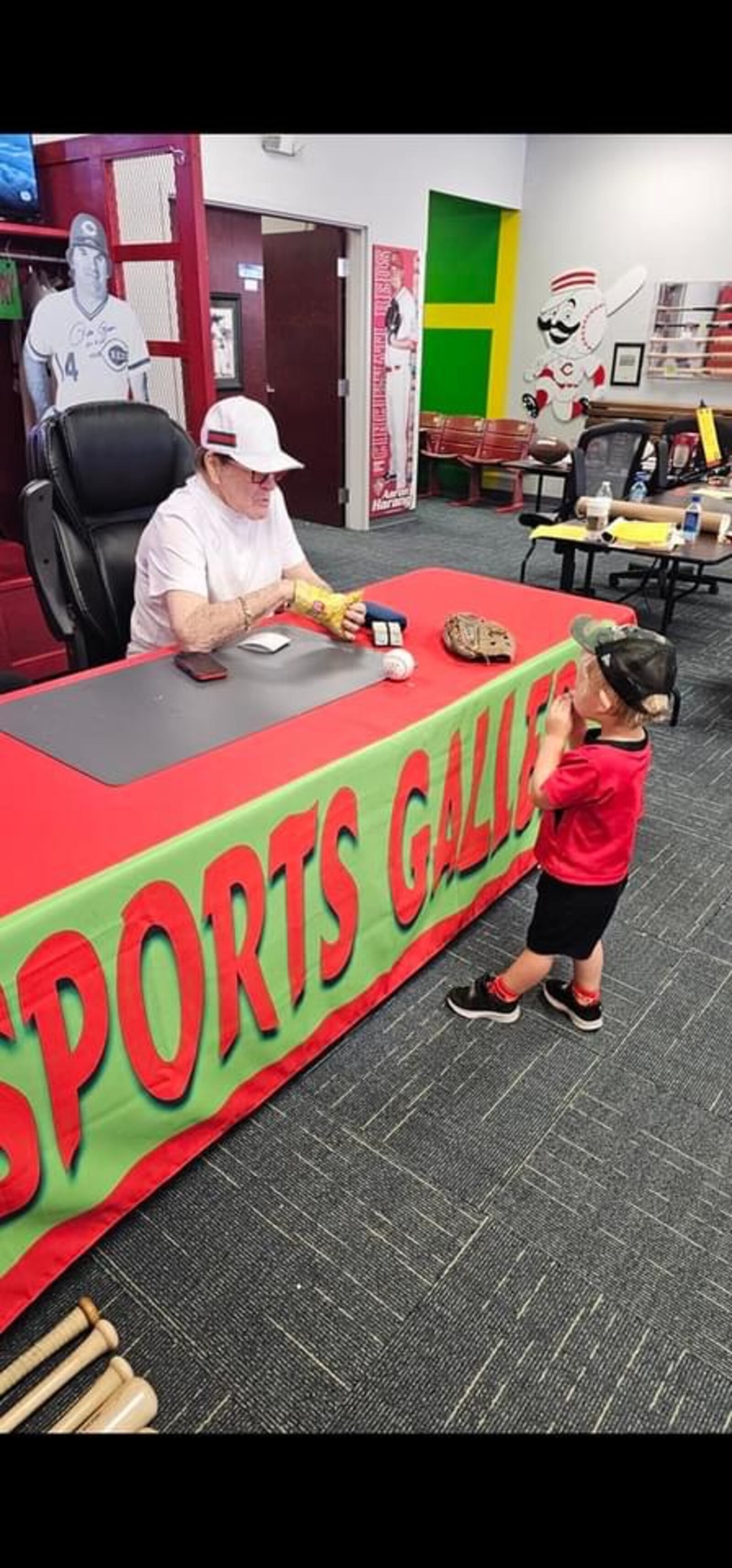 After a recent autograph signing at Sports Gallery, Pete Rose shares a bag of chips with Jett, Mark Fugate's grandson. Rose died Monday. He was 83. SUBMITTED PHOTO