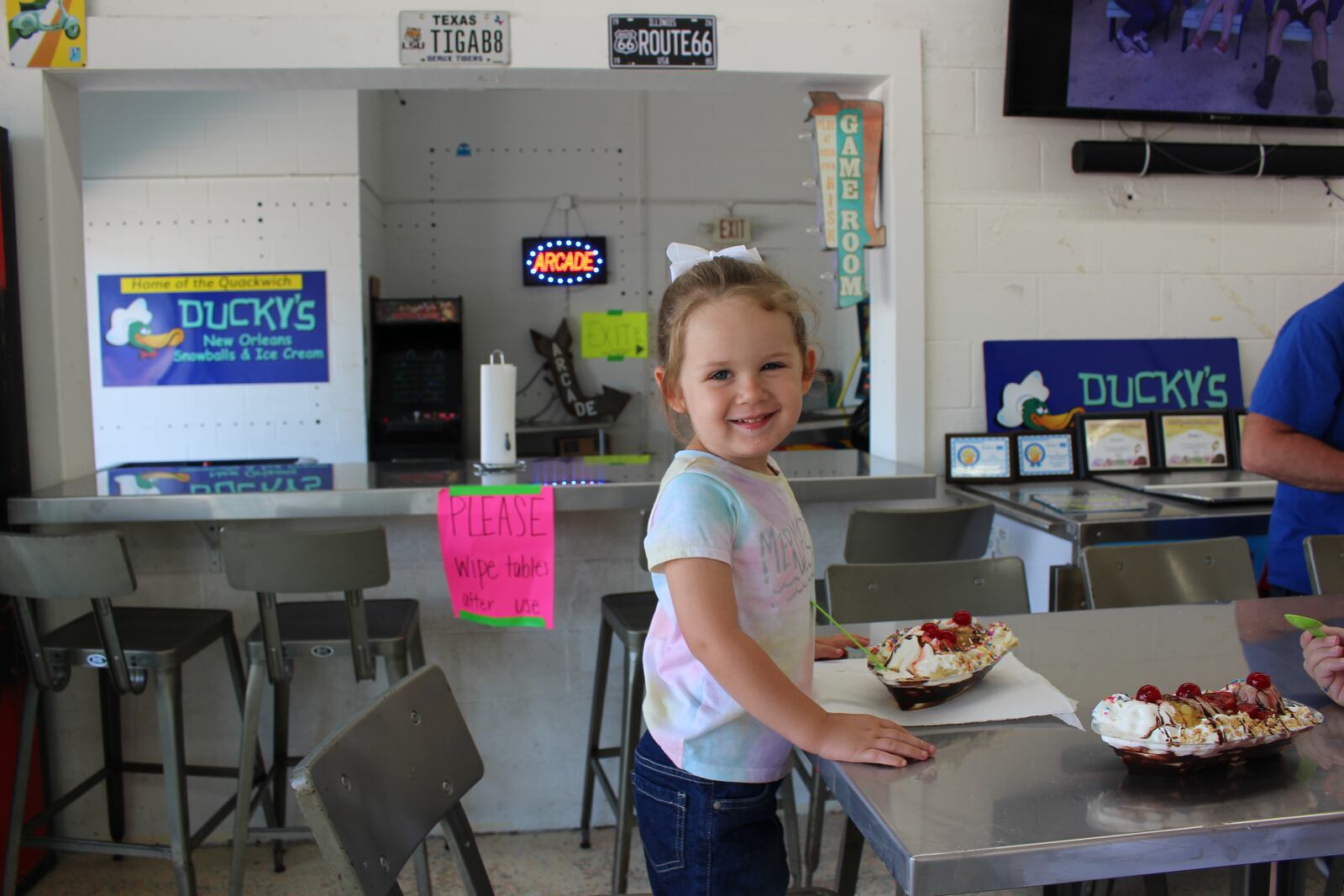 Young girl enjoys banana split from Ducky's Snowballs and Ice Cream in Troy.