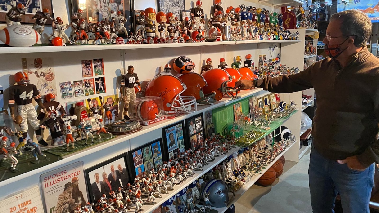 Charlie McMahan, senior pastor at Southbrook Christian Church in Miamisburg, has repurposed or enhanced thousands of items on display in the basement of his Centerville home, including this wall dedicated to the Cleveland Browns. PHOTOS BY STEVE MORRISON/CONTRIBUTED