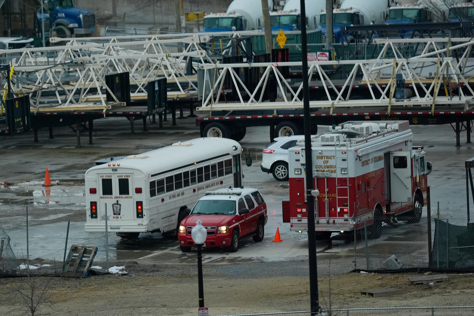 Emergency vehicles are seen across the Potomac River near Ronald Reagan Washington National Airport, Friday, Jan. 31, 2025, in Washington. (AP Photo/Carolyn Kaster)