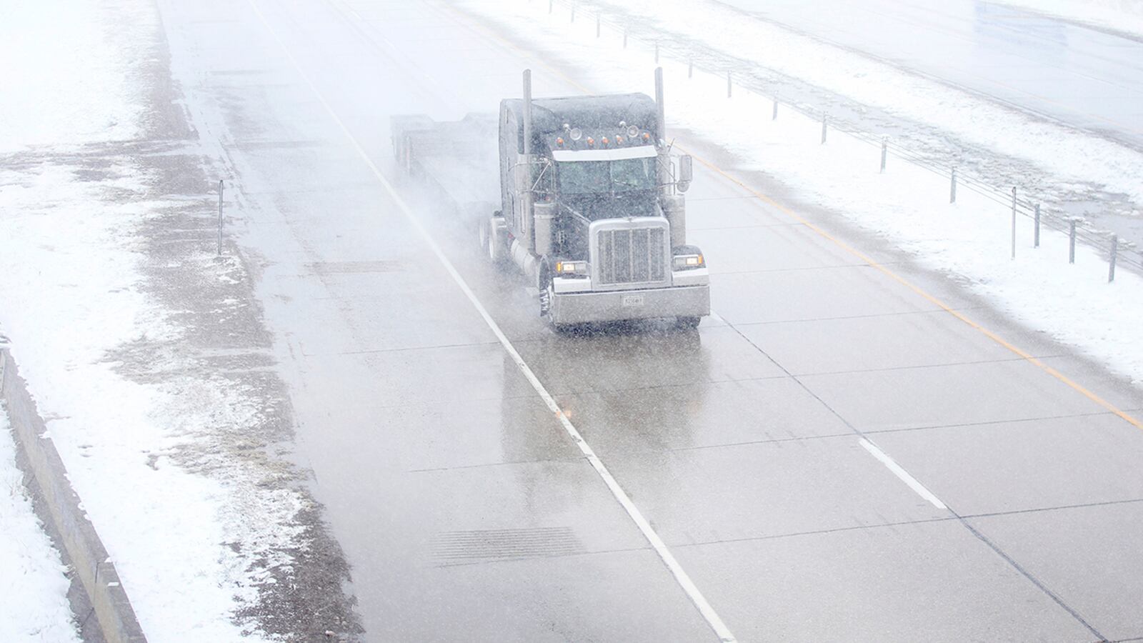 A truck travels east on Interstate 80 during a blizzard warning hitting southeast Wyoming and the Colorado Front Range on Wednesday, April 10, 2019, in Cheyenne. People in Colorado, Wyoming and South Dakota, among other states were urged to get home early Wednesday and stay there before snow and wind from a powerful spring storm make travel all but impossible.