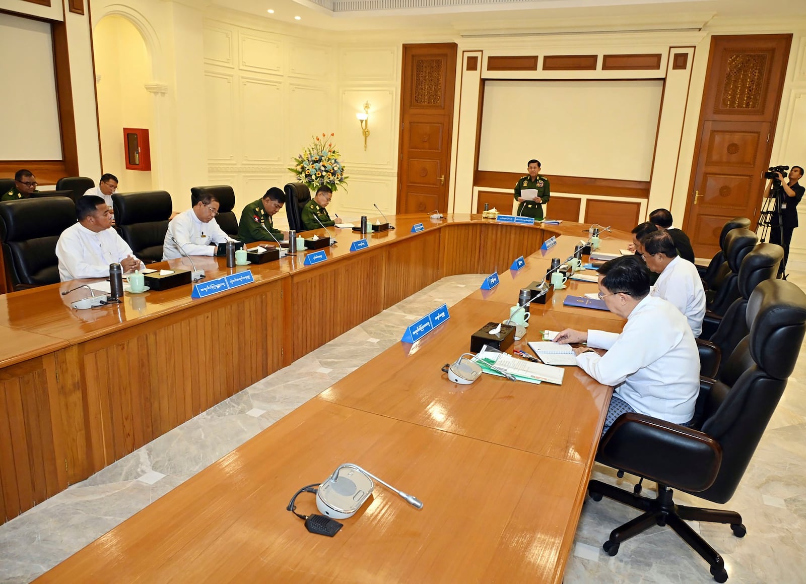 In this image provided by The Myanmar Military True News Information Team, Myanmar's military leader Senior Gen. Min Aung Hlaing, center, speaks during meeting with members of the National Defense and Security Council Friday, Jan. 31, 2025, in Naypyitaw, Myanmar.(The Myanmar Military True News Information Team via AP)