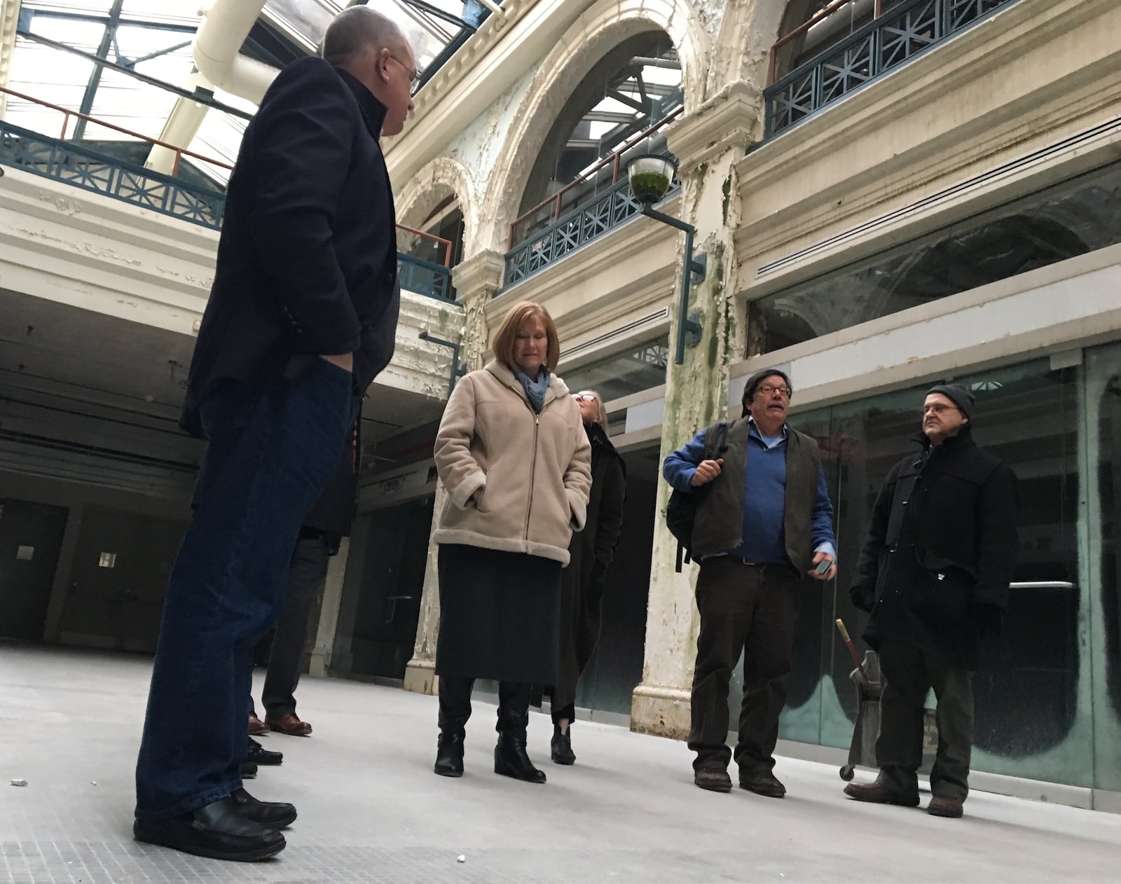 Developers and city of Dayton leaders and officials tour the Third Street Arcade building. Developers propose creating a marketplace of pop-up restaurants on the ground floor and micro apartment units on the upper levels. CORNELIUS FROLIK / STAFF