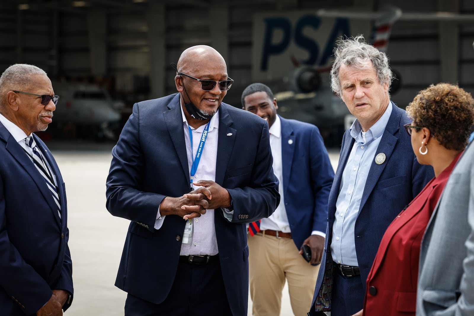 From left, Dayton Mayor Jeff Mims Jr., Director of Aviation at the Dayton International Airport Gil Turner, Ohio Sen. Sherrod Brown and Deputy Dayton City Manager LaShea Lofton tour the Dayton International Airport Friday July 15, 2022. Later the group formed a roundtable discussion about infrastructure investment at the Dayton International Airport. JIM NOELKER/STAFF