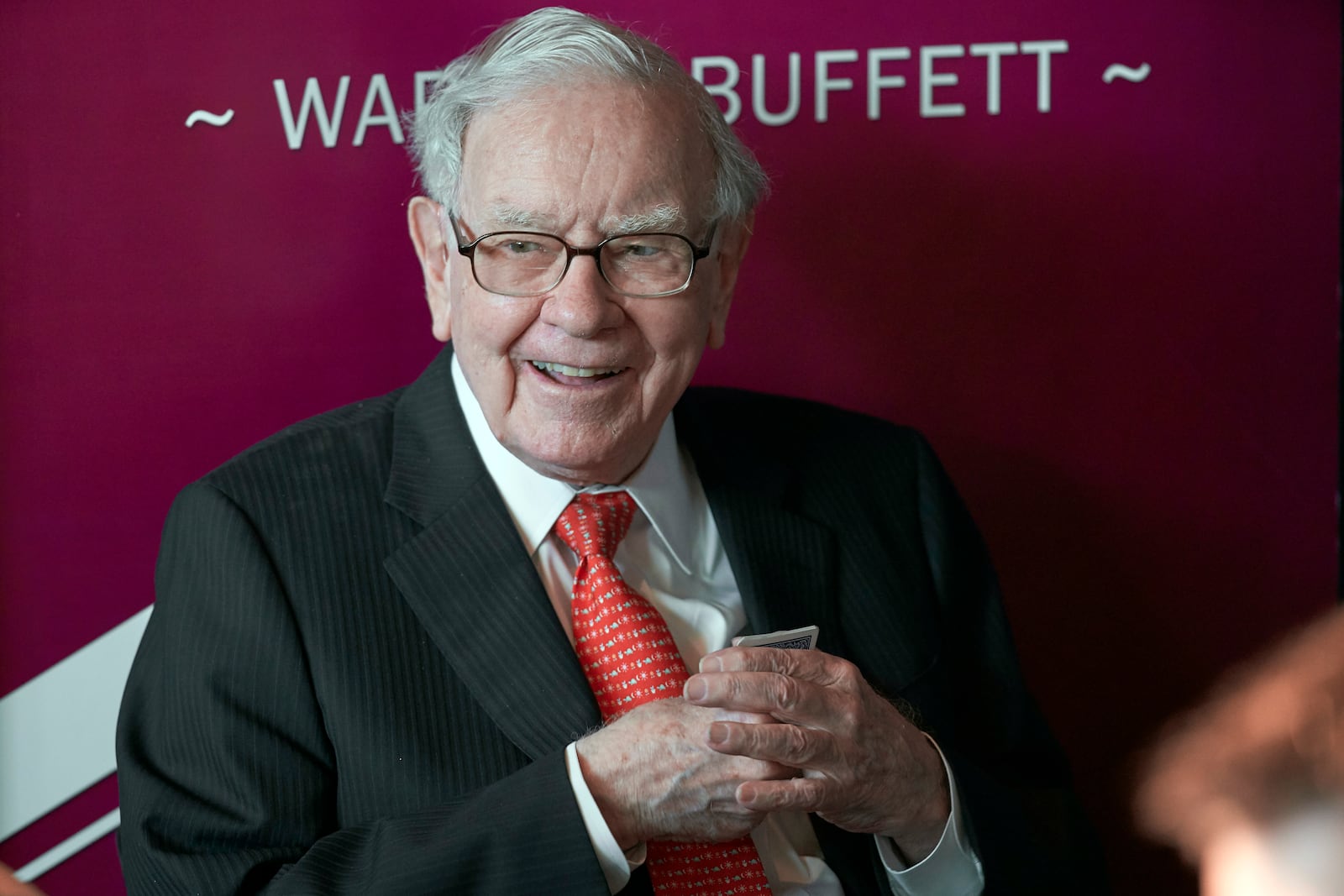 FILE - Warren Buffett, chairman and CEO of Berkshire Hathaway, smiles as he plays bridge following the annual Berkshire Hathaway shareholders meeting in Omaha, Neb., May 5, 2019. (AP Photo/Nati Harnik, File)