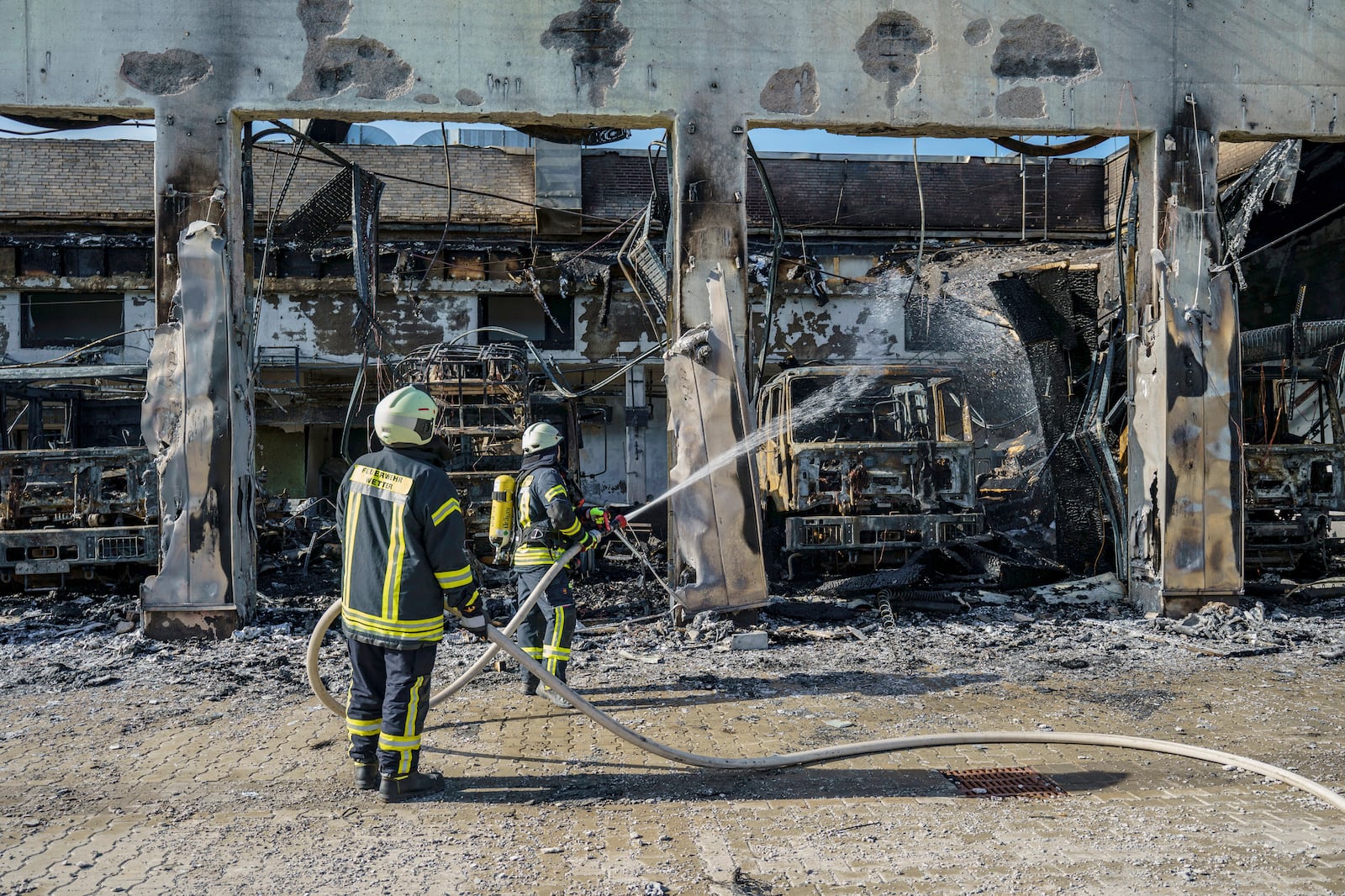 Firefighters work on the site of a fire in a vehicle depot in Stadtallendorf, Germany, Wednesday Oct. 16, 2024. (Andreas Arnold/dpa via AP)