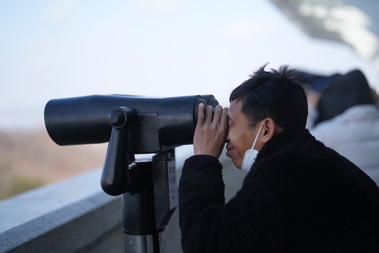 A visitor watches North Korean side from the unification observatory in Paju, South Korea, Wednesday, Jan. 29, 2025. (AP Photo/Lee Jin-man)