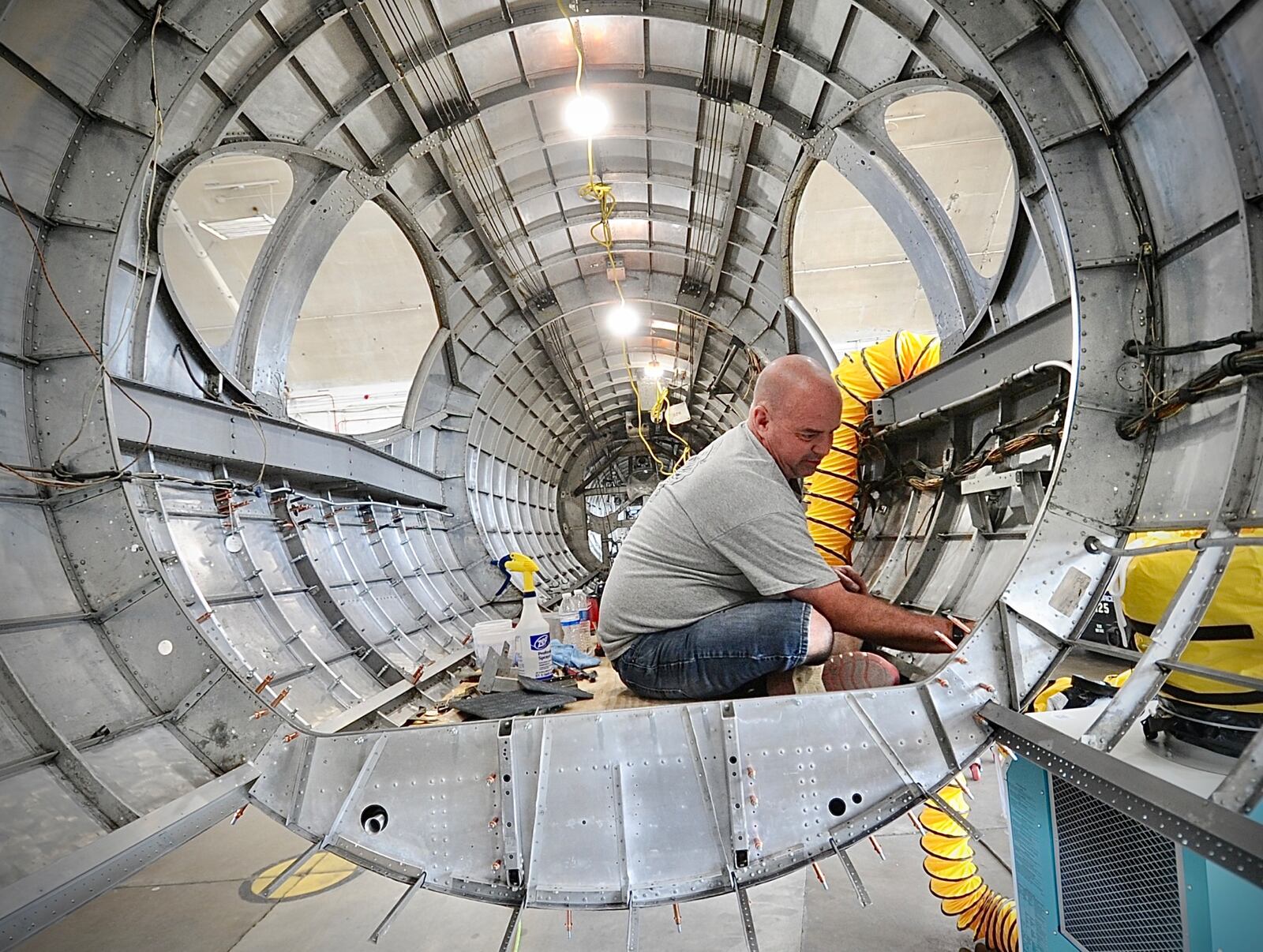 Duane Jone member of the restoration team for the Museum of the United States Air Force works inside The Swoose a Boeing B-17 D. The Swoose is the only existing Boeing B-17 D. MARSHALL GORBY \STAFF