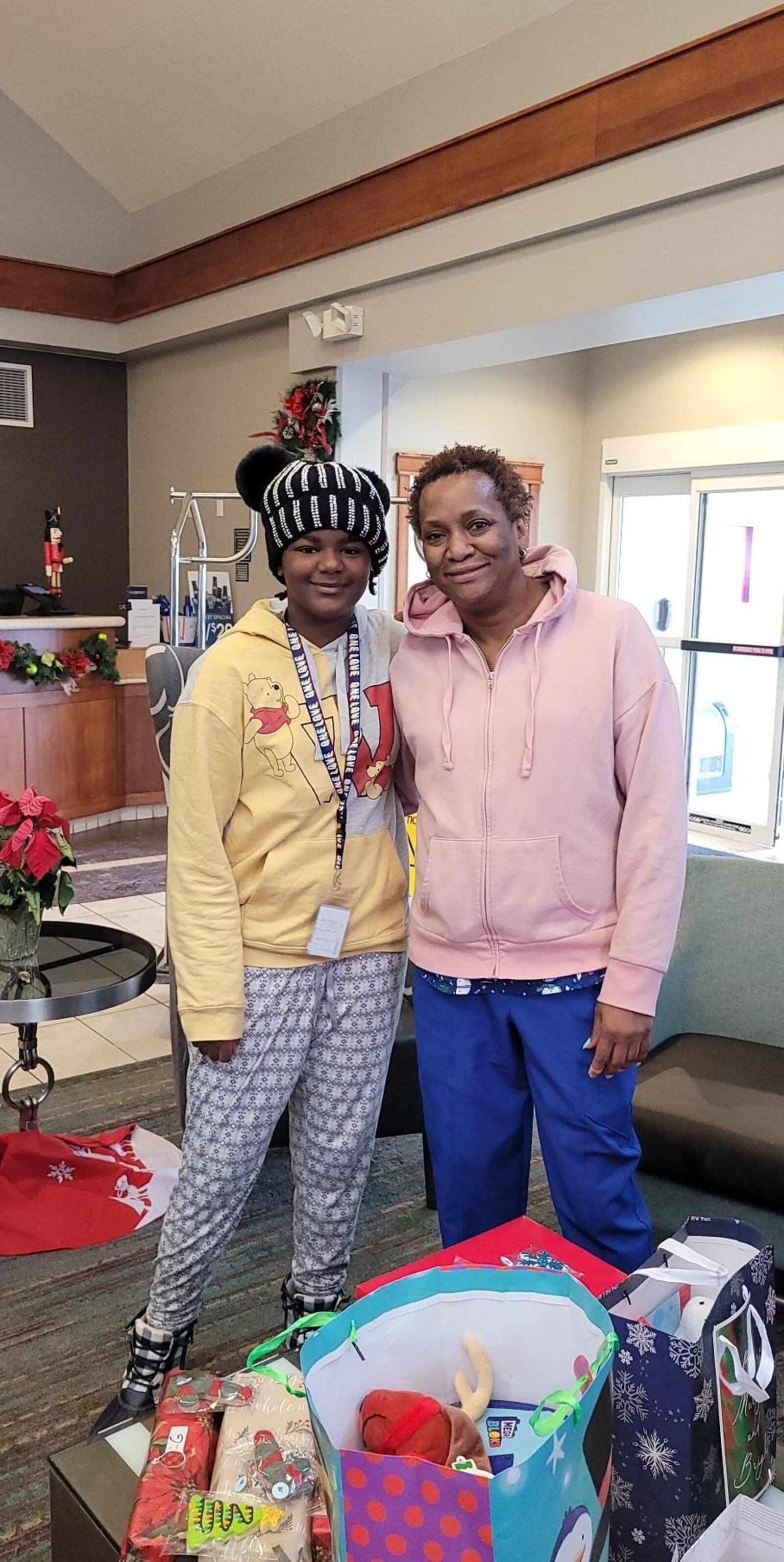 Sheila Ryder (right) and her granddaughter Jewel after they were visited on Christmas Eve by fireman of Dayton FireFighters Local 136 who delivered gifts from a ladder truck and a medical vehicle as part of their “Christmas From The Firehouse”, an annual drive that once again was aided by the horsemen of Dayton Raceway. CONTRIBUTED