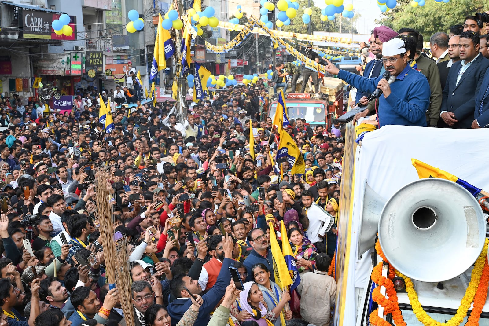 Aam Aadmi Party (AAP) national convenor Arvind Kejriwal, right, speaks during a show as he campaigns for Delhi state election in New Delhi, India, Monday, Feb. 3, 2025. (AP Photo)