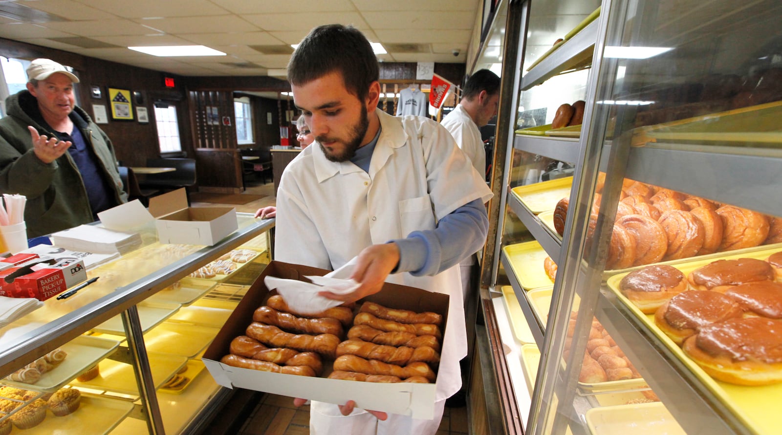 Bill's Donut Shop employee Robby Lavoie fills an order on Wednesday, February 27, 2013 in Centerville. TY GREENLEES / STAFF