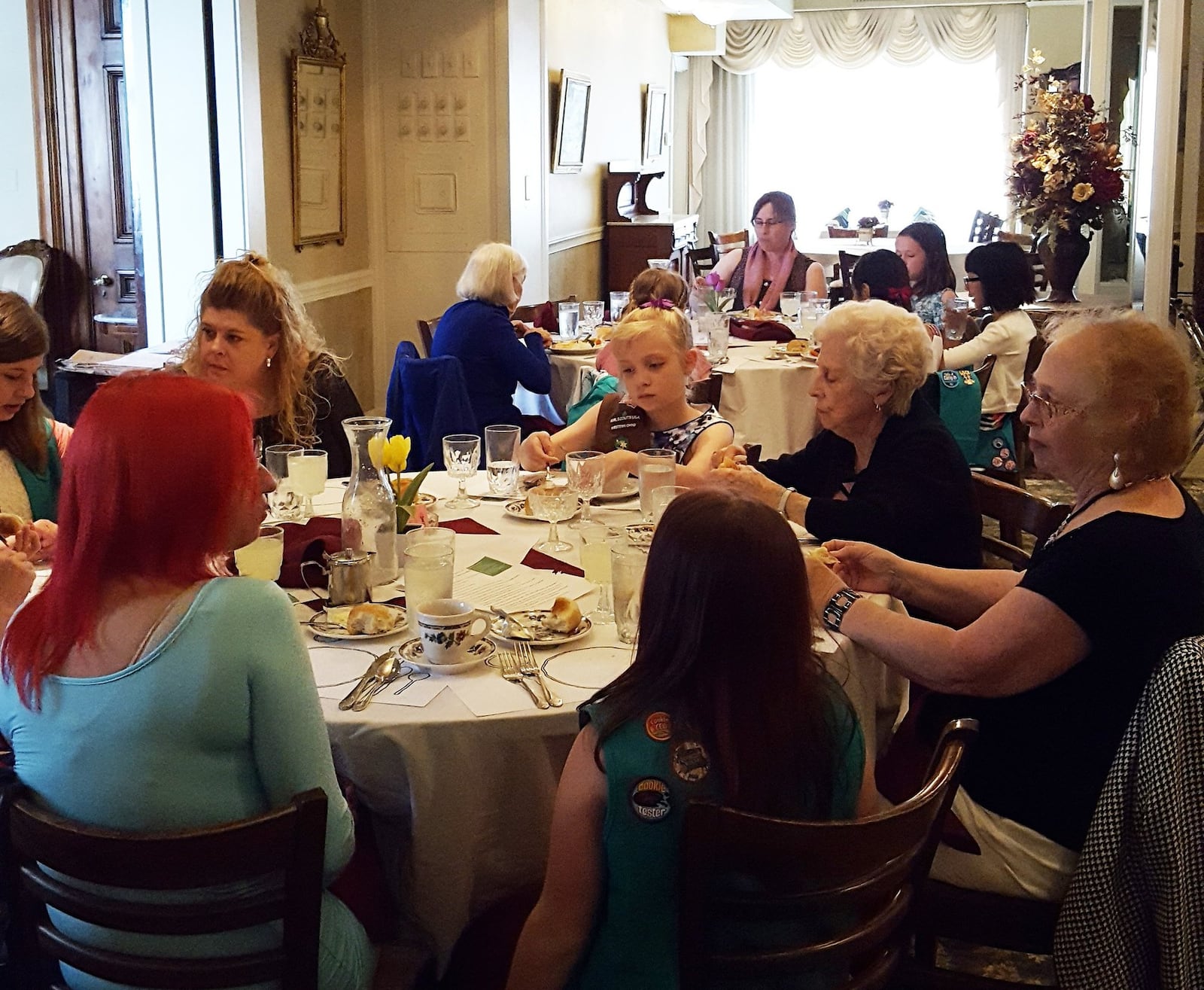 Girls sit at their prepared places after serving themselves the bread and butter in a manners program at the Dayton Woman’s Club. CONTRIBUTED