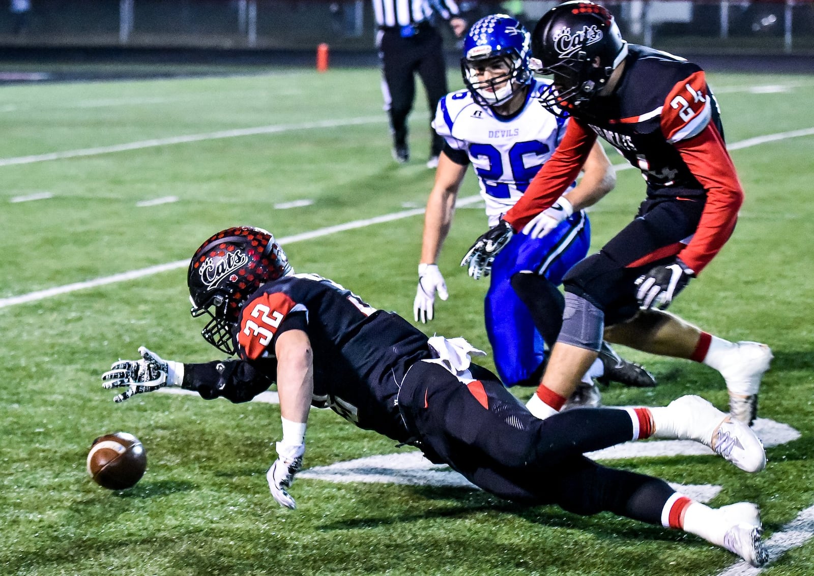 Franklin’s Matt Centers recovers a fumbled kickoff as teammate Logan Willis (24) and Brookville’s Bailey Wallen (26) watch during Thursday night’s game at Atrium Stadium in Franklin. NICK GRAHAM/STAFF