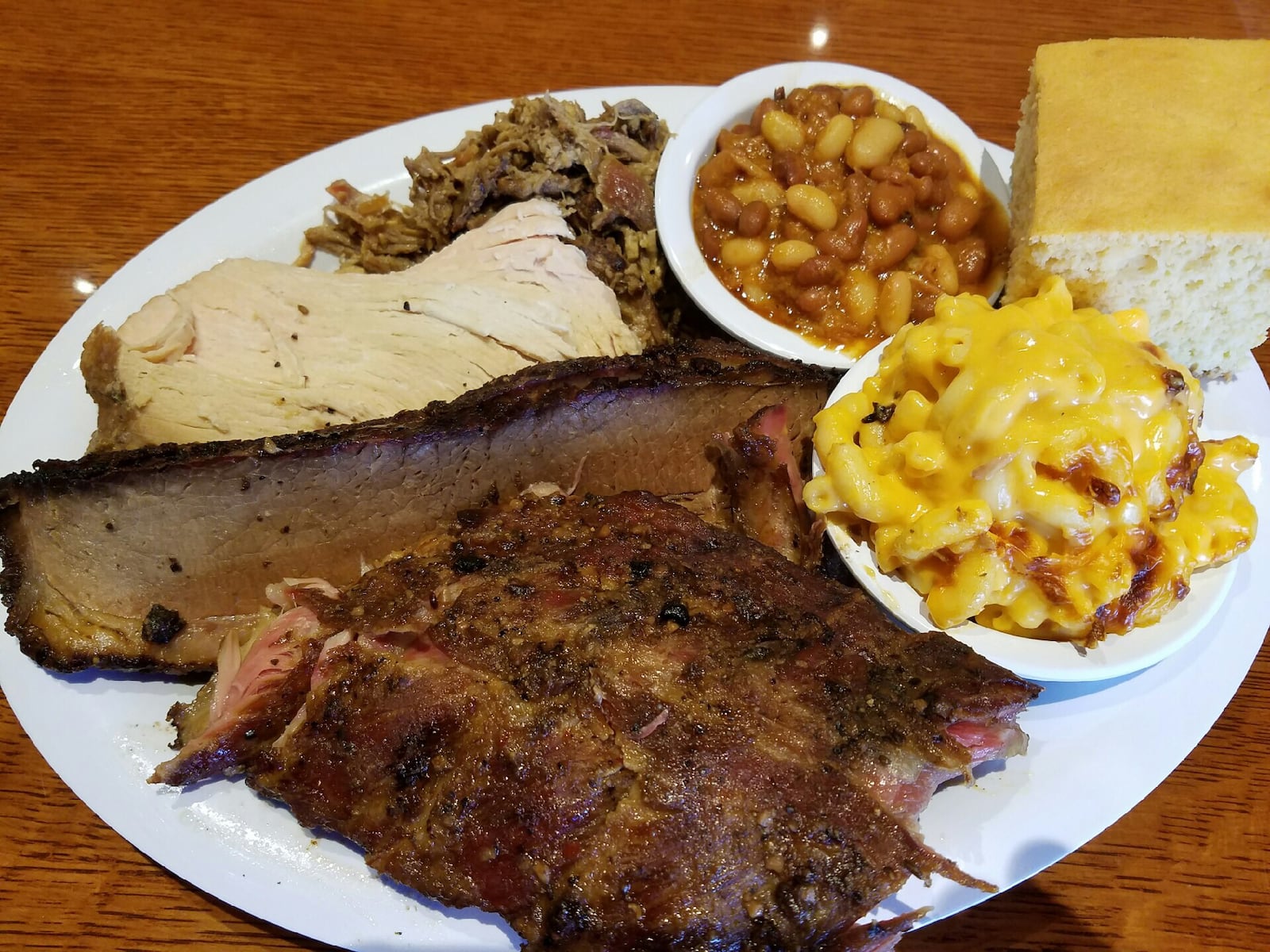 The  four-meats combo dinner at Company 7 BBQ in Englewood. Options include pork, brisket, sausage, turkey, rib meat, chicken or meatloaf.  The four-meat meal is $25.   There is a $2 up charge for each rib meat. Photo: Will Grilliot/Company 7 BBQ