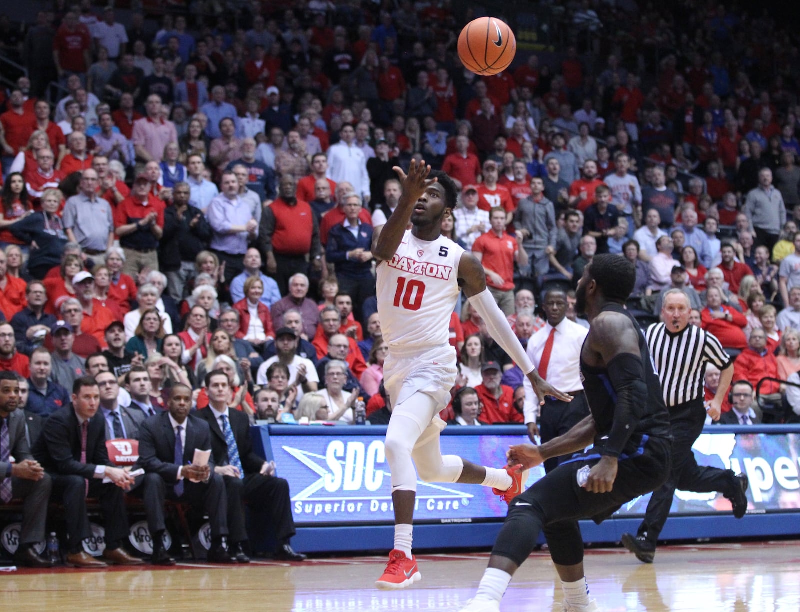 Dayton’s Jalen Crutcher throws an alley-oop pass to Trey Landers against Saint Louis on Tuesday, Feb. 20, 2018, at UD Arena.