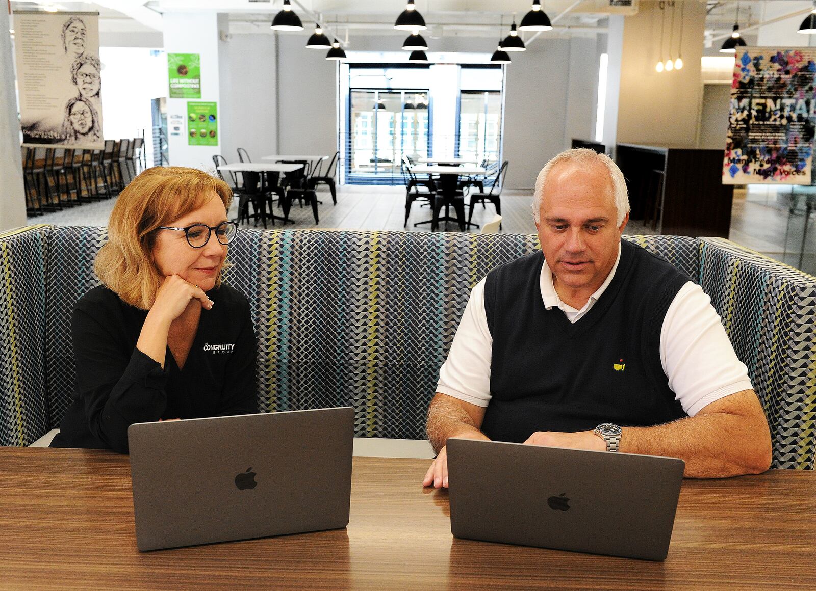 Paul Boeckman, global business development leader, works with Besty Westhafer, CEO of The Congruity Group, at The Hub in Downtown Dayton. Boeckman retired as an executive with Synchrony in 2021 and decided in to return to work part-time at The Congruity Group. MARSHALL GORBY\STAFF