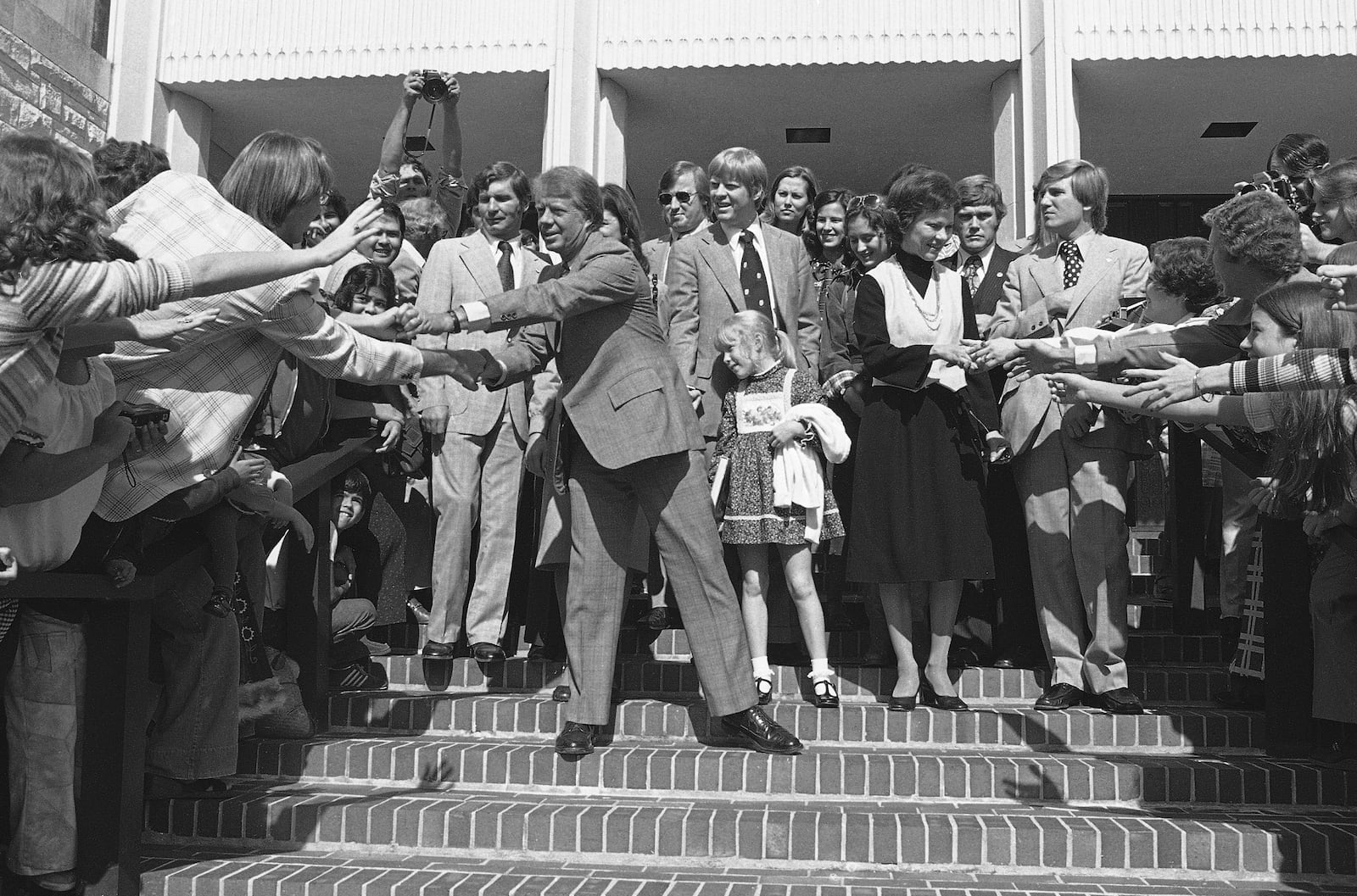 FILE - Democratic Presidential candidate Jimmy Carter and his wife Rosalynn Carter greet people after attending church services at the University Baptist Church near the end of his presidential election campaign on Oct. 31, 1976, in Fort Worth, Texas. (AP Photo/John Duricka, File)