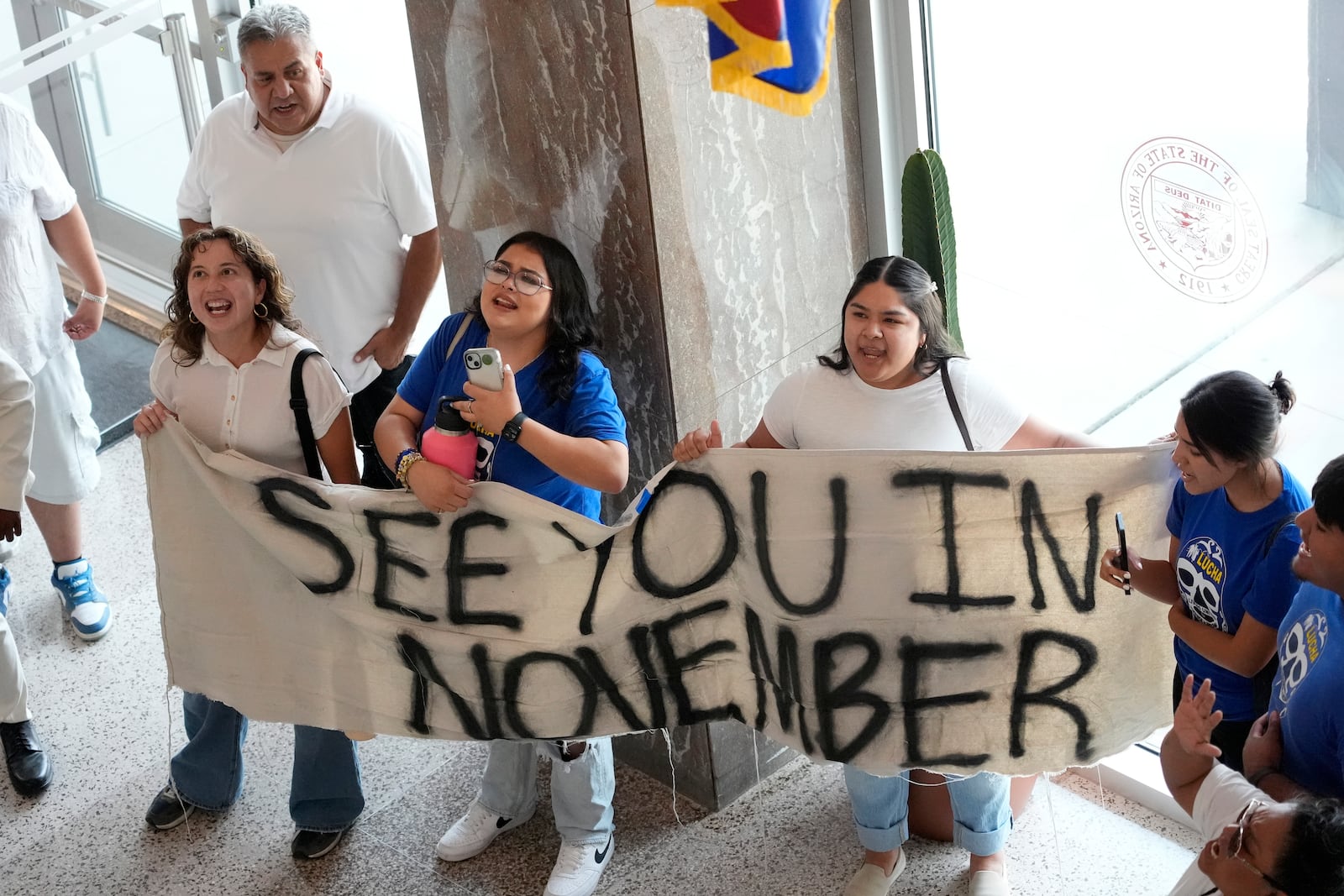 FILE - Opponents gather inside the Arizona State Capitol, June 4, 2024, in Phoenix after the Arizona legislature gave final approval to a proposal that will ask voters to make it a state crime for noncitizens to enter the state through Mexico at any location other than a port of entry. (AP Photo/Matt York, File)