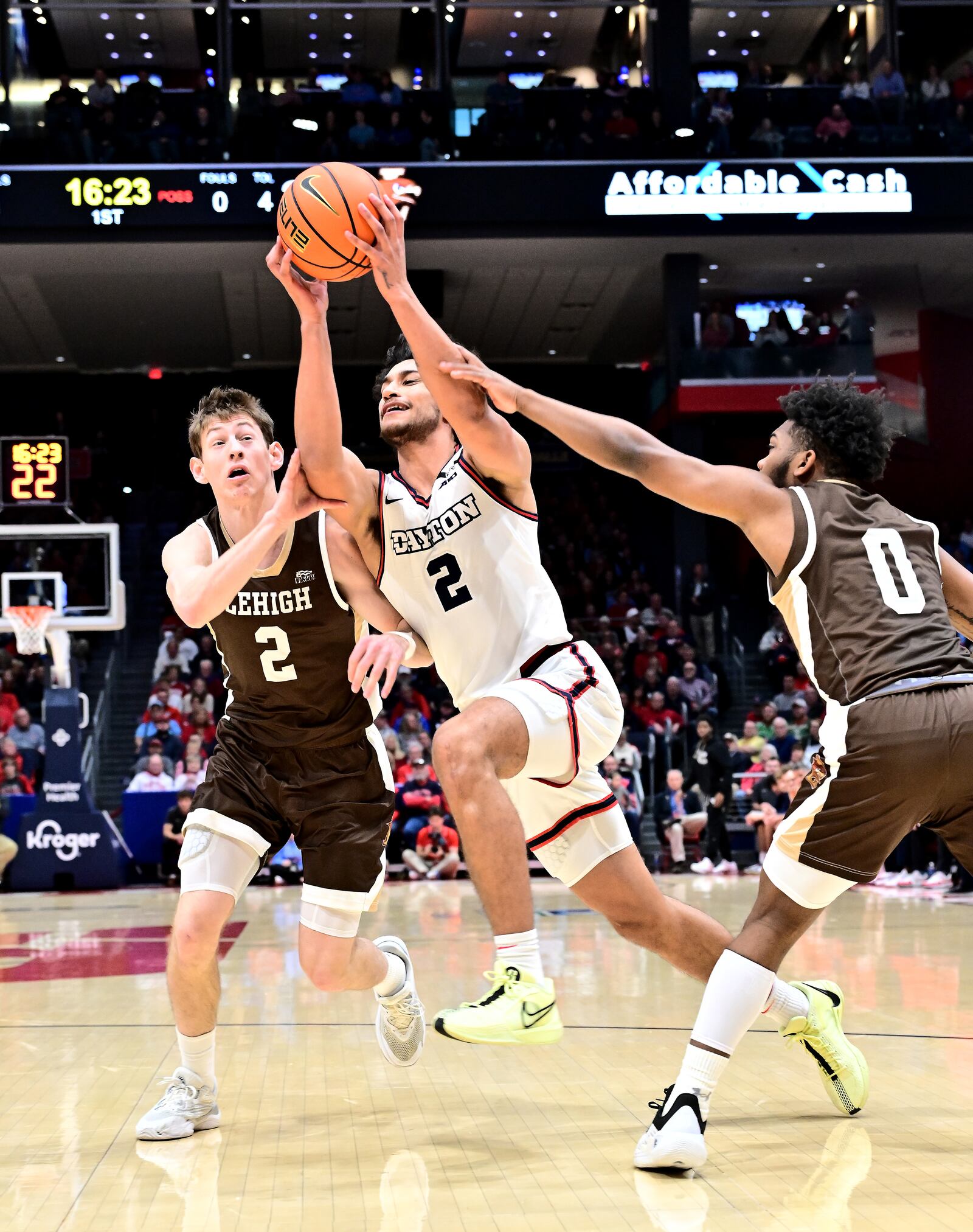 Dayton's Nate Santos splits Lehigh defenders Ben Knostman (2) and Cam Gillus during Saturday's game at UD Arena. Erik Schelkun/UD Athletics photo