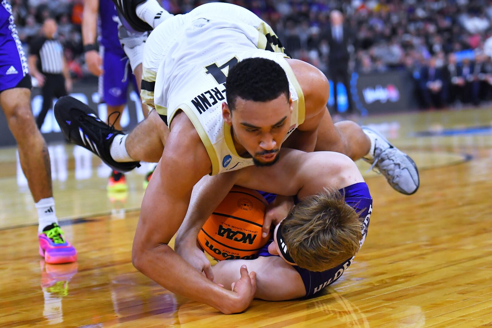 Purdue forward Trey Kaufman-Renn, top, battles High Point forward Simon Hildebrandt for the ball during the second half in the second round of the NCAA college basketball tournament, Thursday, March 20, 2025, in Providence, R.I. (AP Photo/Steven Senne)