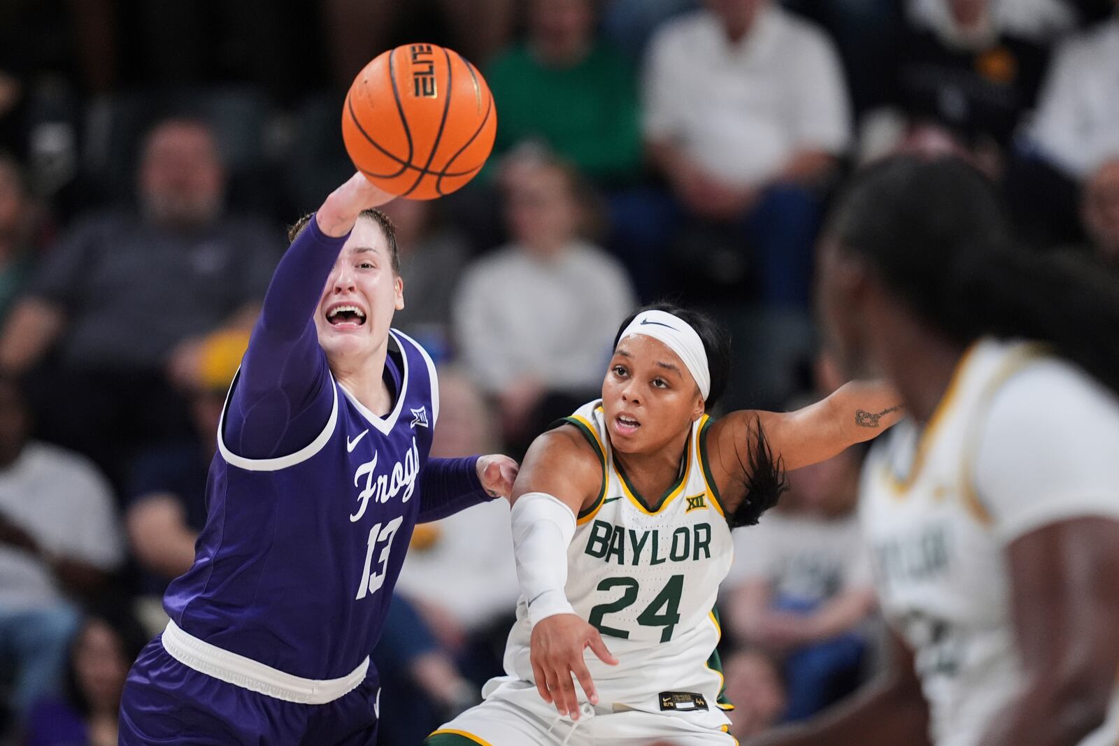 TCU's Sedona Prince (13) and Baylor's Sarah Andrews (24) compete for a loose ball in the first half of an NCAA college basketball game in Waco, Texas, Sunday, March 2, 2025. (AP Photo/Tony Gutierrez)