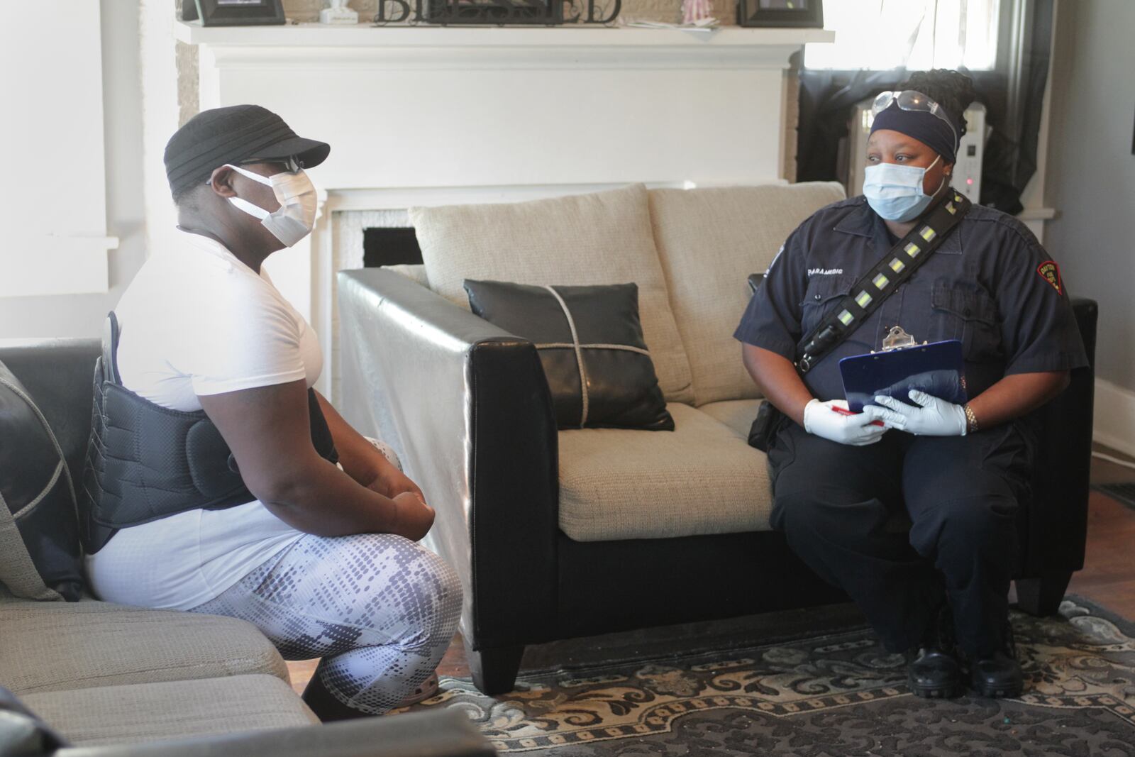 Community Paramedicine staff on the right, Kendra Harris, provides personalized health and wellness support to Teasha Young at her home in Dayton..