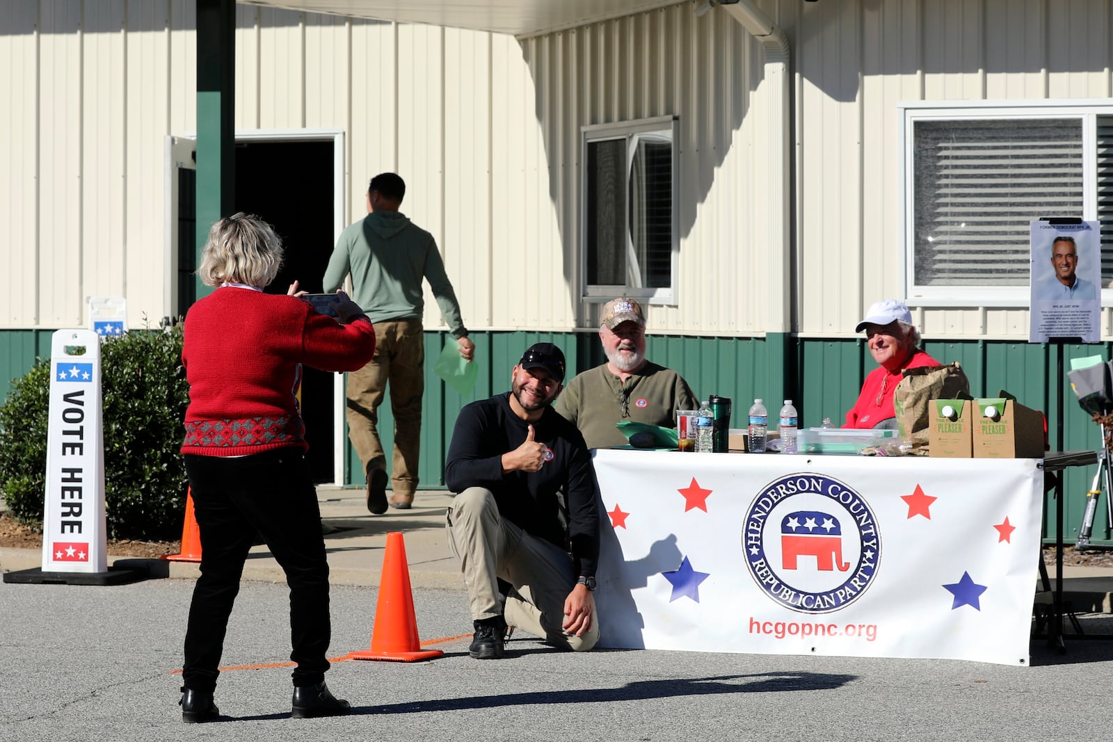 Francisco Gonzalez poses for a picture at the Henderson County Republican Party table after voting for Donald Trump at the Henderson County Board of Elections on the first day of early voting in the state, Thursday, Oct. 17, 2024, in Hendersonville, N.C. (AP Photo/Jeffrey Collins)