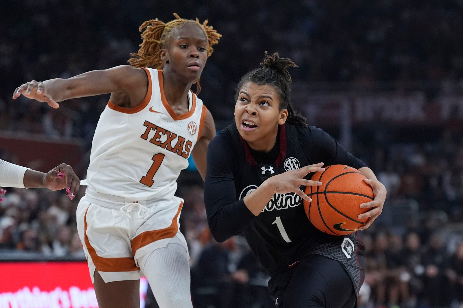 South Carolina guard Maddy McDaniel, right, drives against Texas guard Bryanna Preston, left, during the first half of an NCAA college basketball game in Austin, Texas, Sunday, Feb. 9, 2025. (AP Photo/Eric Gay)