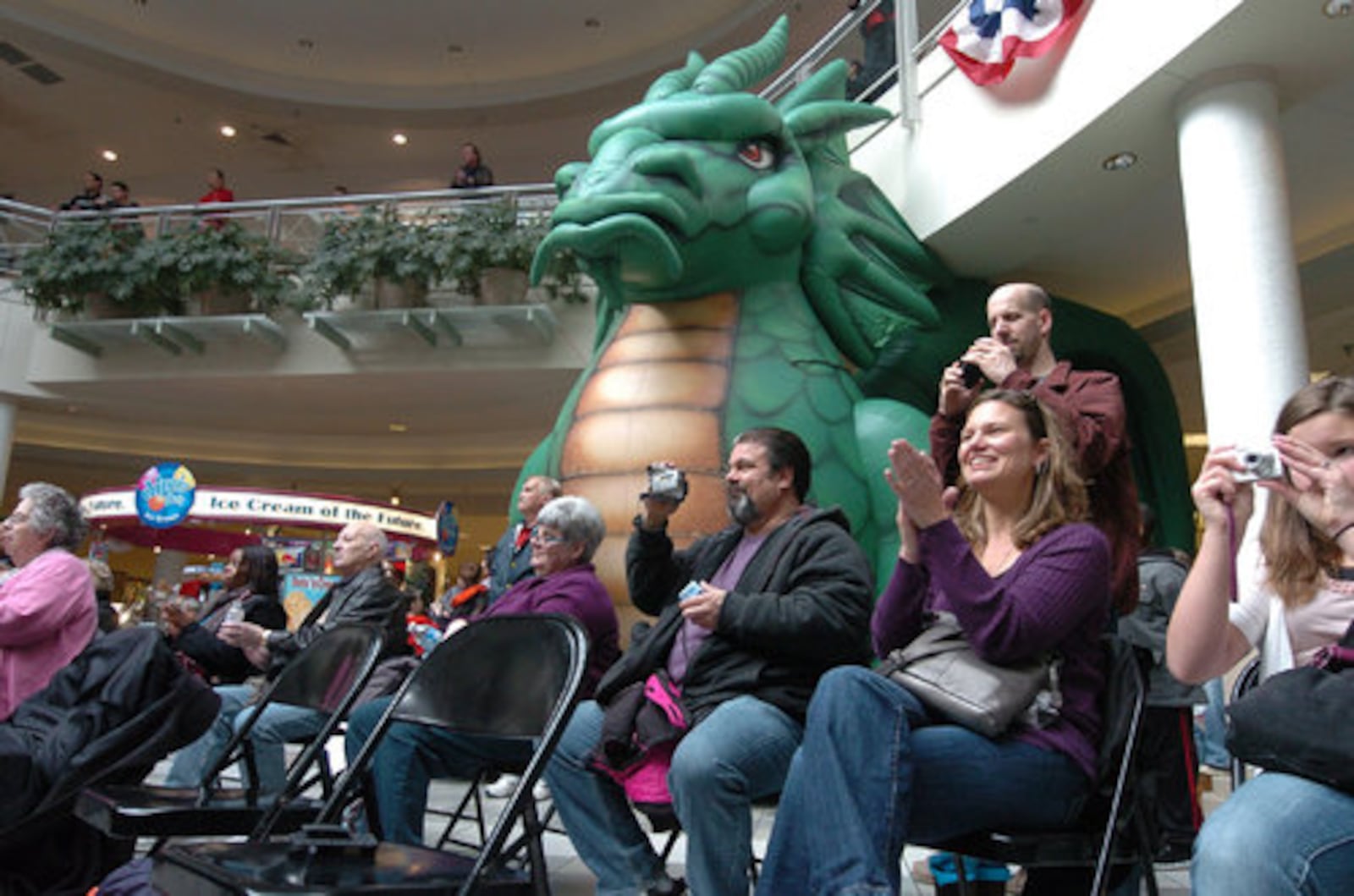 Shoppers watch the National Anthem auditions at the Dayton Mall on Saturday for the Dayton Dragons season opening game