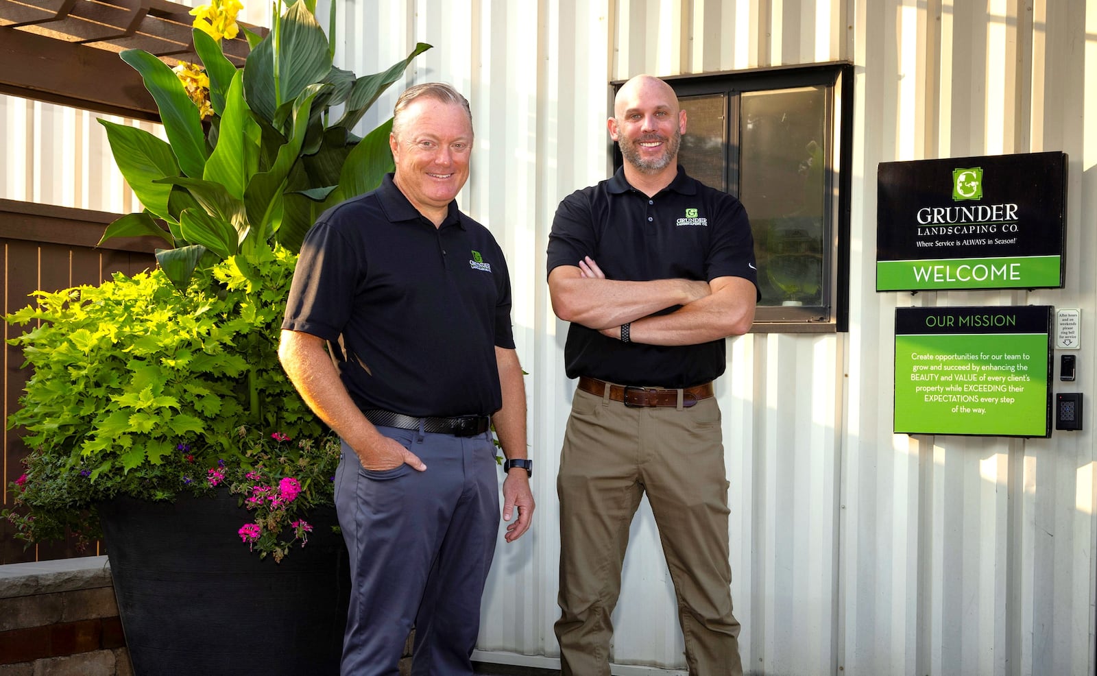 Grunder Landscaping Co. founder and CEO Marty Grunder and company President and Chief Operating Officer Seth Pflum stand outside Grunder Landscaping at 1900 Byers Road in Miamisburg. Founded in 1984, the business recently launched renovations on a Loveland facility ahead of a planned November opening. CONTRIBUTED