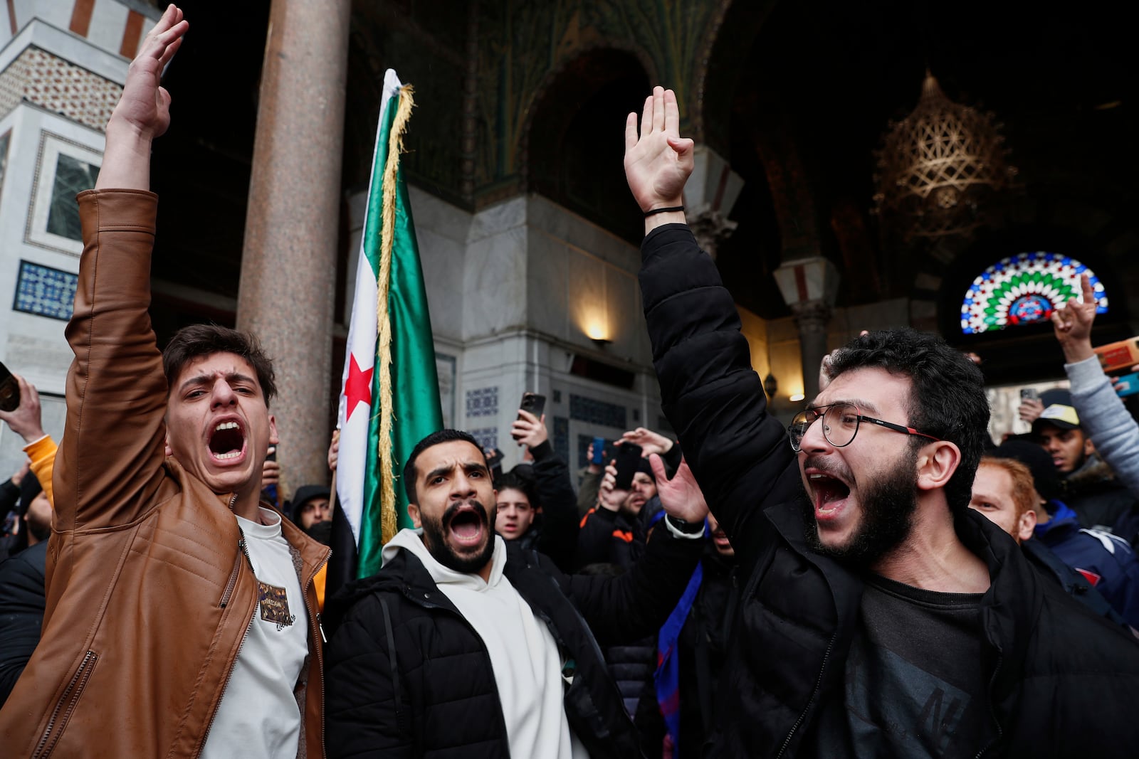 Syrian government supporters shout slogans to show their solidarity with the security forces who are fighting against gunmen loyal to former President Bashar Assad during a protest in Damascus, Syria, Friday, March 7, 2025. (AP Photo/Omar Sanadiki)