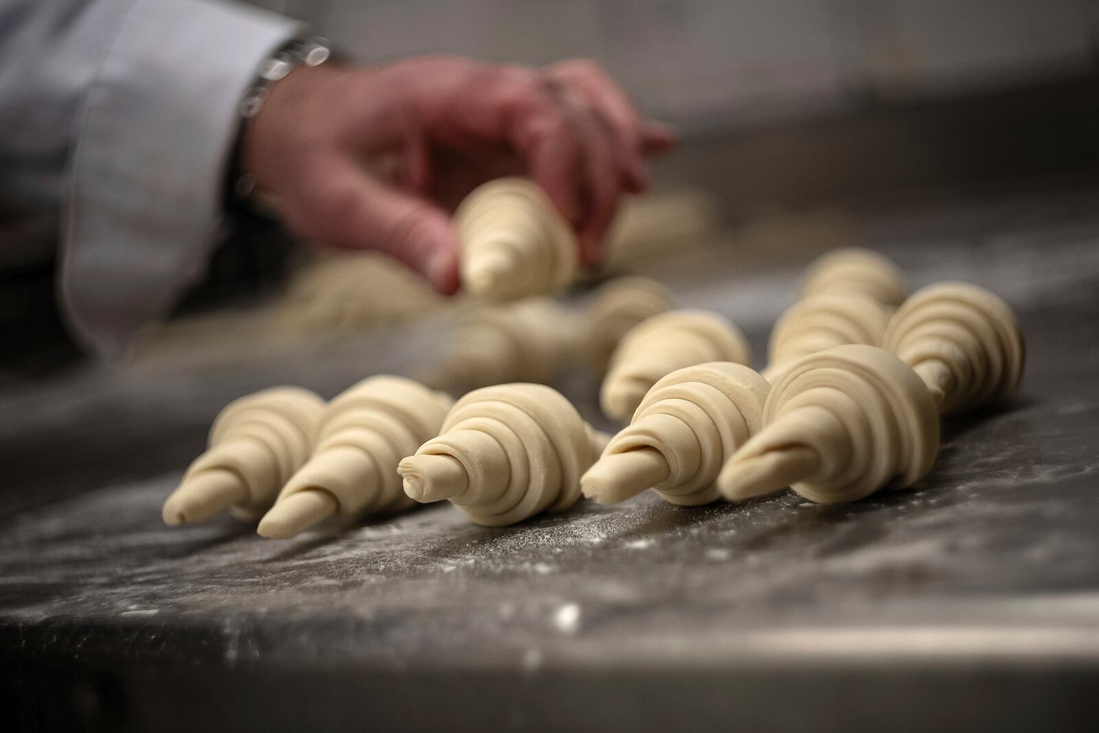 French baker Arnaud Delmontel bakes butter croissants in Paris, Monday, Dec. 16, 2024 as butter has shot up in price across Europe in recent months, adding more pain to consumers this holiday season after years of inflation in the wake of the COVID-19 pandemic and war in Ukraine.(AP Photo/Aurelien Morissard)