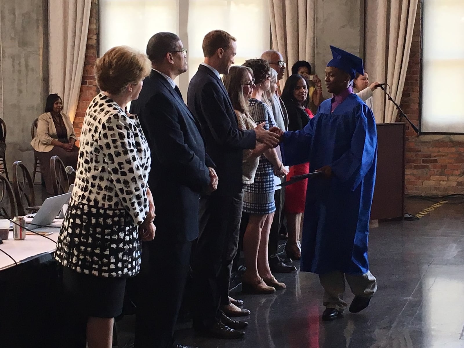 Dayton Public Schools leaders congratulate 2018 summer graduates at a school board meeting. JEREMY P. KELLEY / STAFF