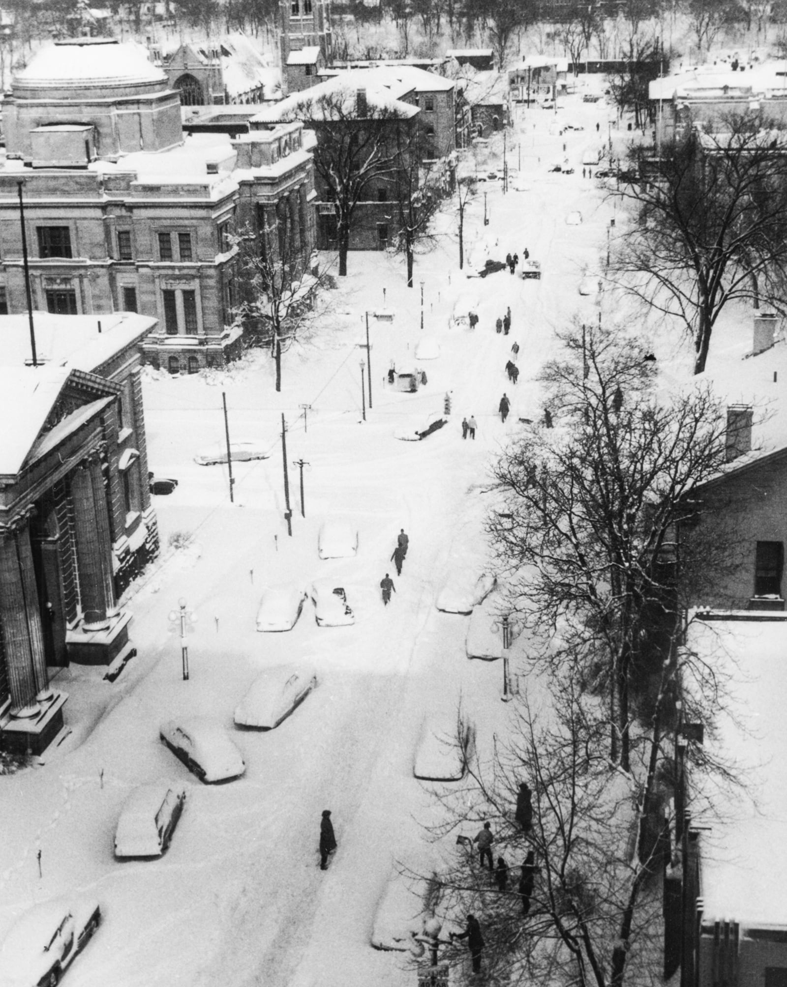 November 25 marks the anniversary of the November 1950 storm of the century that blasted the eastern United States and blanketed much of Ohio on the Saturday following Thanksgiving. This scene here, captured by then Springfield News Sun photographer Howdy Weber shows a view looking north up Limestone just as people were beginning to dig themselves out from the historic storm that left hundreds stranded, and called for a six day city-wide state of emergency. Photo Courtesy of the Clark County Historical Society