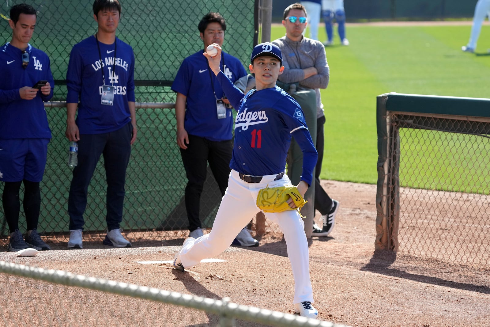 Los Angeles Dodgers pitcher Roki Sasaki (11) throws during his first live bullpen session during spring training baseball practice, Wednesday, Feb. 19, 2025, in Phoenix. (AP Photo/Darryl Webb)