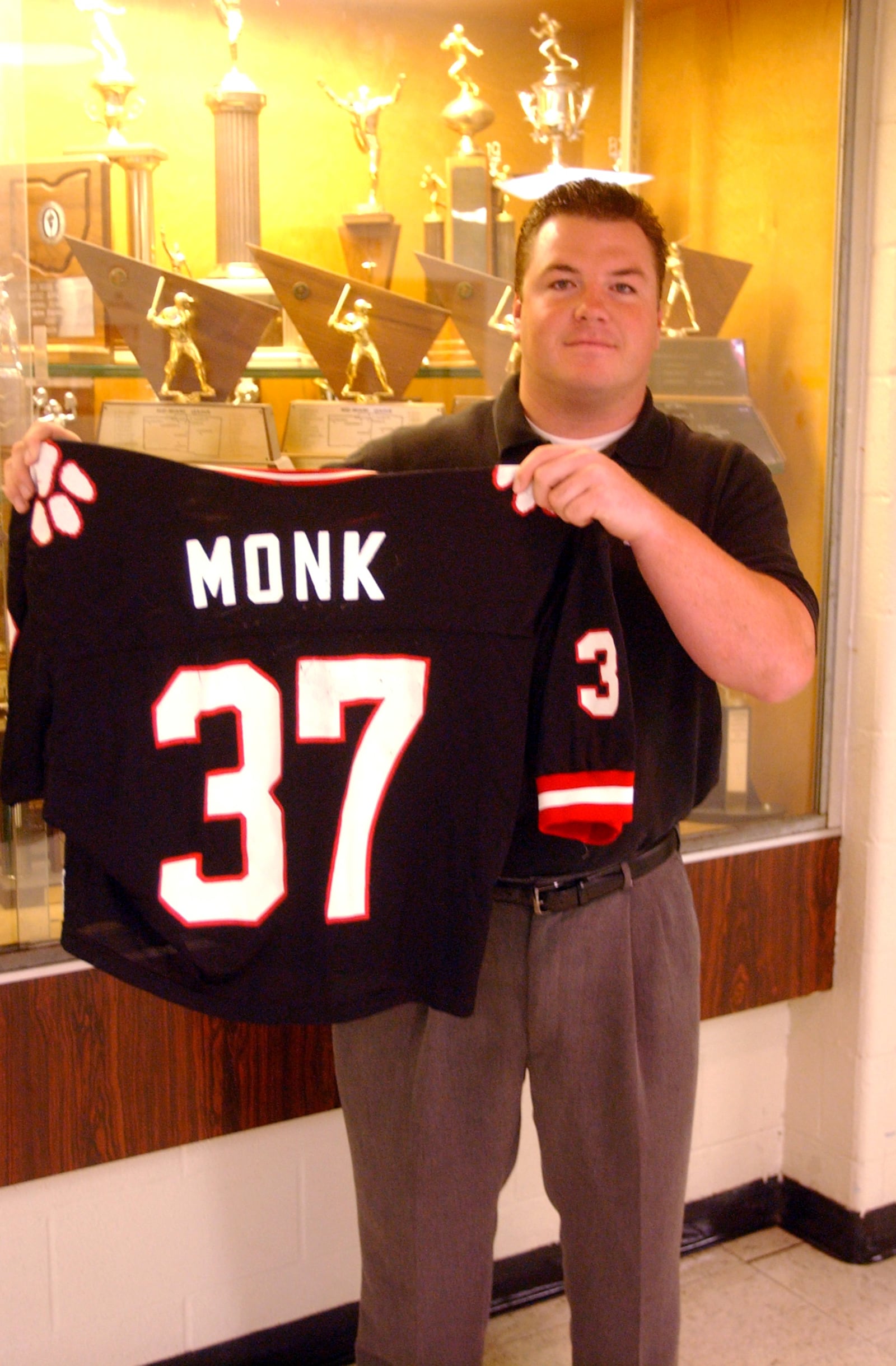 Nick Monk, a former Franklin football player, holds his football jersey. Monk was the first Franklin athlete to have his jersey number retired. STAFF FILE PHOTO/2005