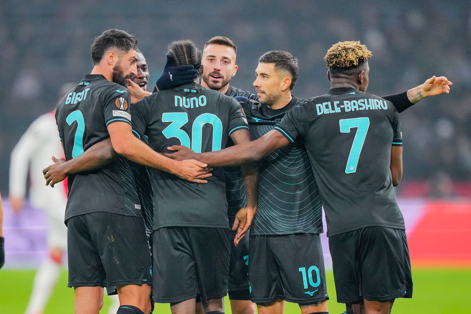 Lazio players celebrate their third team goal during the Europa League soccer match between Ajax and Lazio Roma at the Johan Cruyff Arena in Amsterdam, Netherlands, Thursday, Dec. 12, 2024. (AP Photo/Peter Dejong)