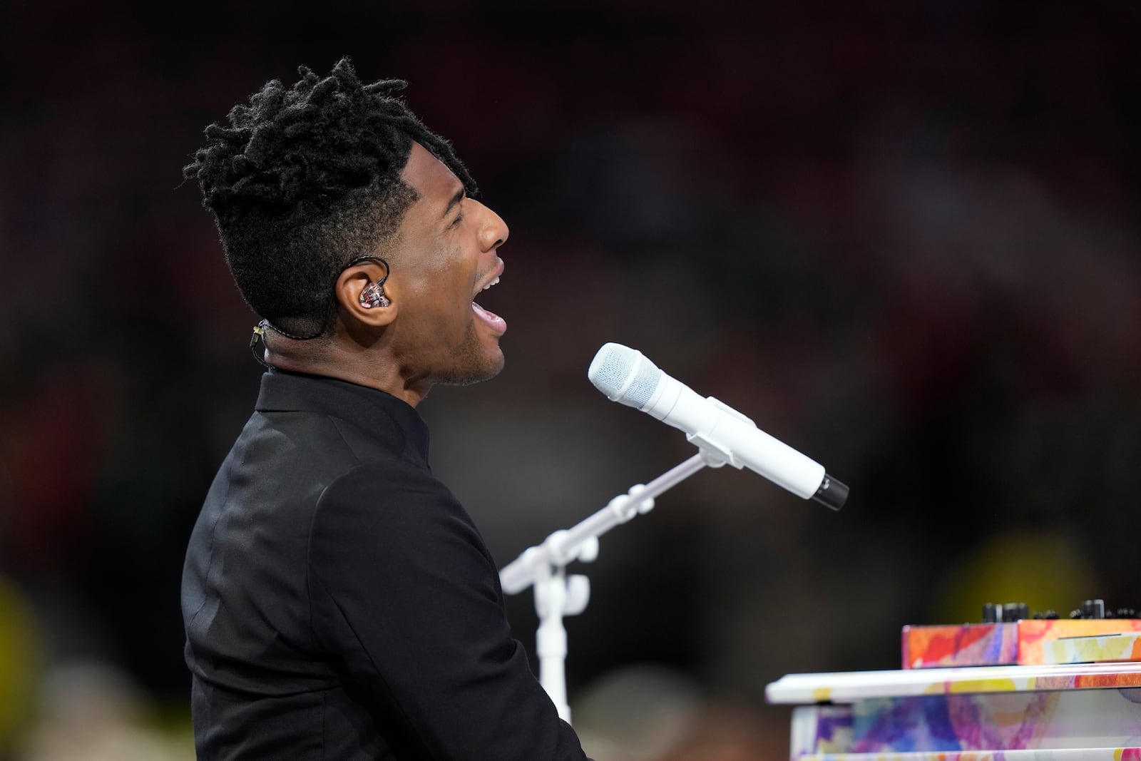 Jon Batiste performs the national anthem before the NFL Super Bowl 59 football game between the Kansas City Chiefs and the Philadelphia Eagles, Sunday, Feb. 9, 2025, in New Orleans. (AP Photo/Doug Benc)