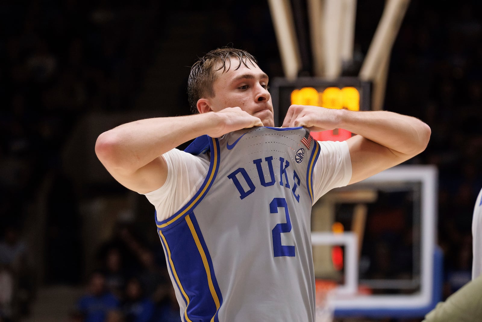 Duke's Cooper Flagg (2) holds his jersey in frustration as he walks off the court during a timeout in an NCAA college basketball game against Army in Durham, N.C., Friday, Nov. 8, 2024. (AP Photo/Ben McKeown)