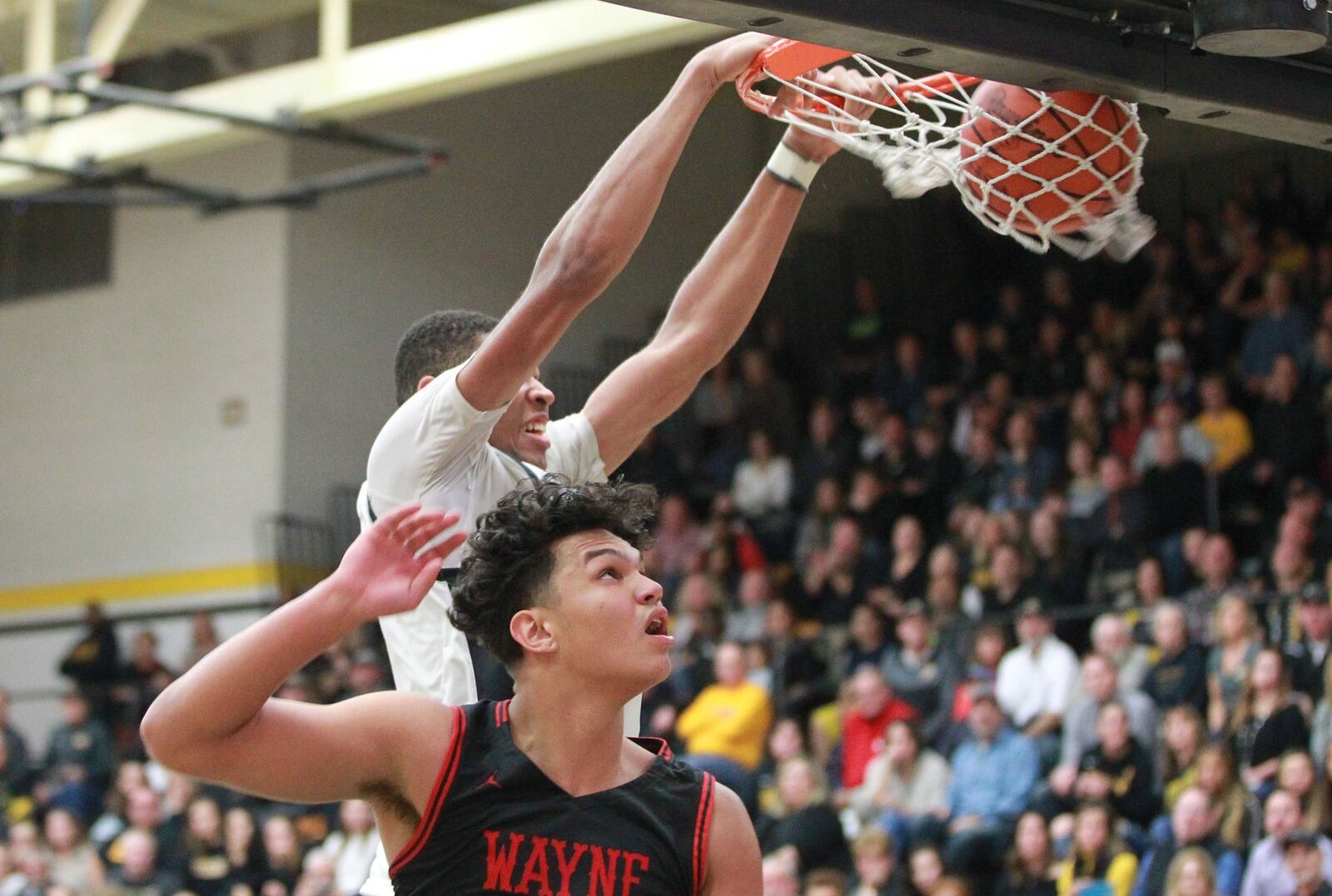 Mo Njie of Centerville dunks over Elijah Brown of Wayne. Wayne defeated host Centerville 52-50 in a GWOC boys high school basketball game on Friday, Dec. 13, 2019. MARC PENDLETON / STAFF