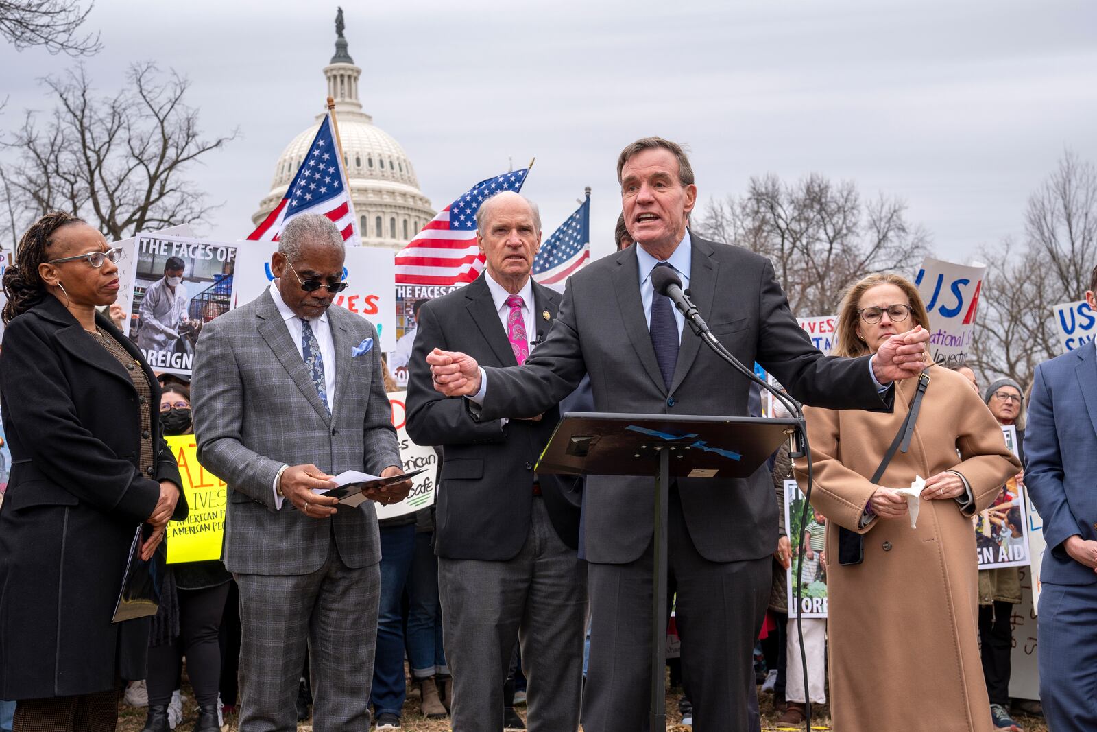 Sen. Mark Warner, D-Va., speaks as demonstrators and lawmakers rally against President Donald Trump and his ally Elon Musk as they disrupt the federal government, including dismantling the U.S. Agency for International Development, which administers foreign aid approved by Congress, on Capitol Hill in Washington, Wednesday, Feb. 5, 2025. (AP Photo/J. Scott Applewhite)