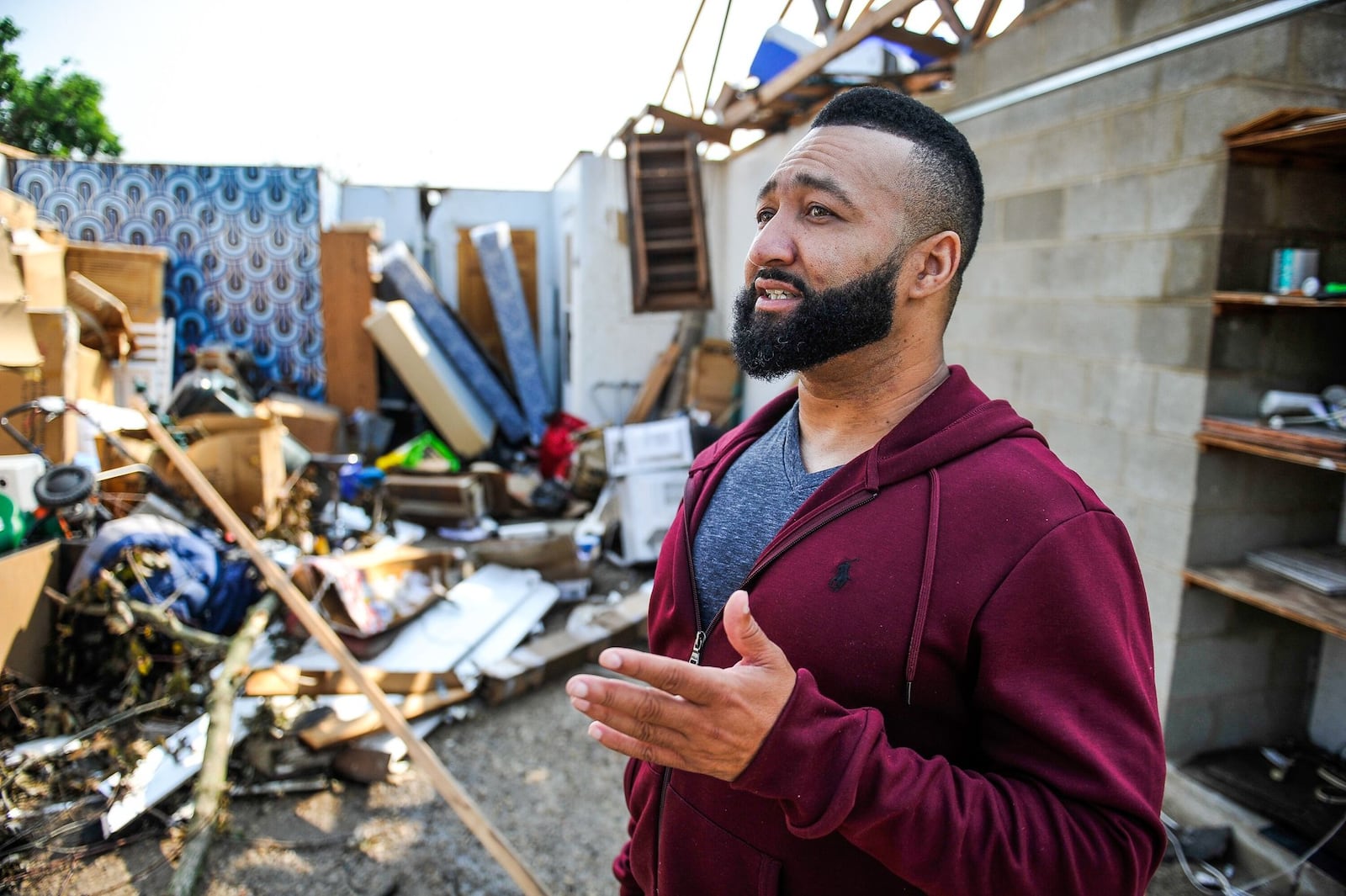 Paris Minniefield, 42, looks at damage to the garage of the house he rents at 5146 Weddington Dr., Trotwood. He said he huddled in the bathroom during the tornado.