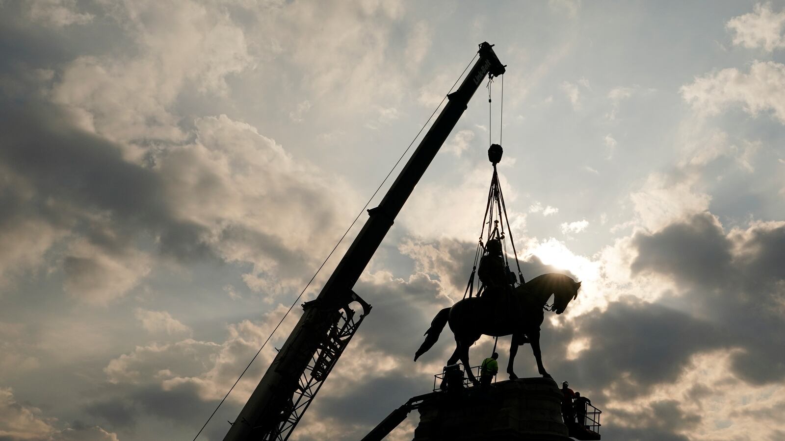 Crews work to remove one of the country's largest remaining monuments to the Confederacy, a towering statue of Confederate Gen. Robert E. Lee on Monument Avenue, Wednesday, Sept. 8, 2021, in Richmond, Va. (AP Photo/Steve Helber, Pool)